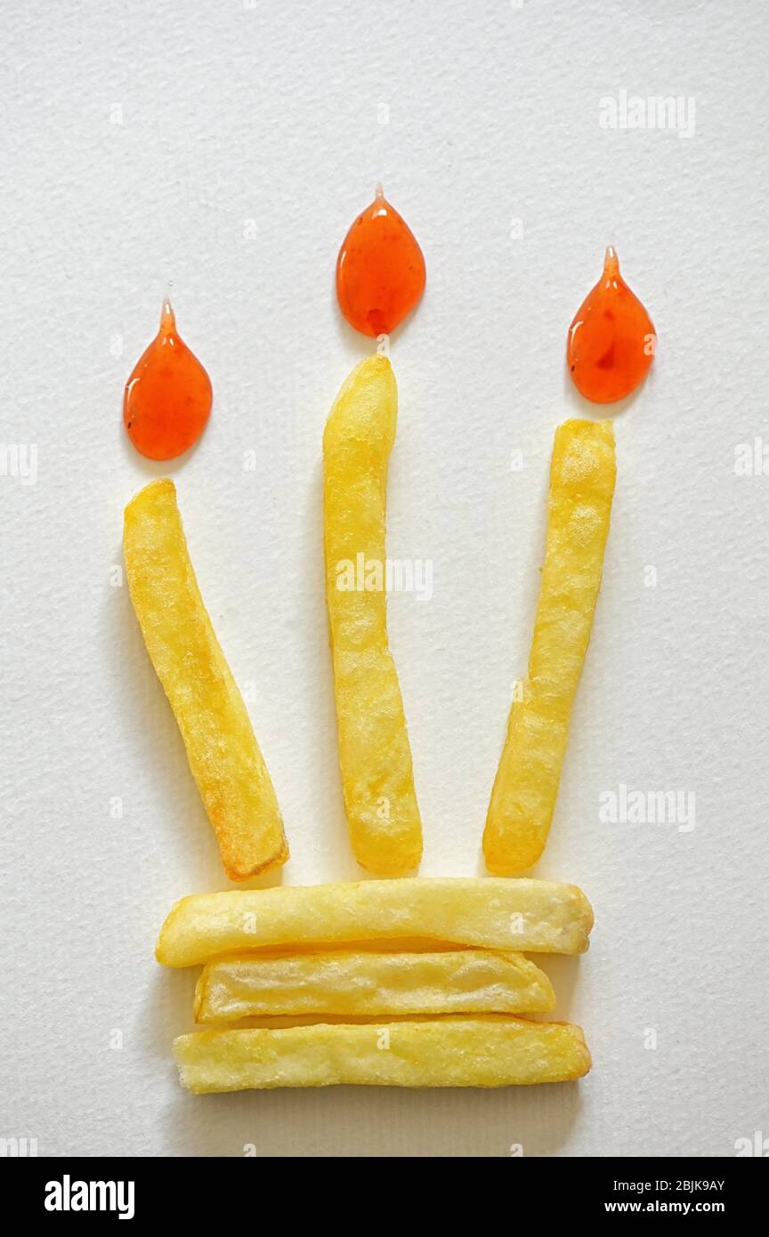 Abstract Birthday Cake With Burning French Fries Candle Stock Photo Alamy