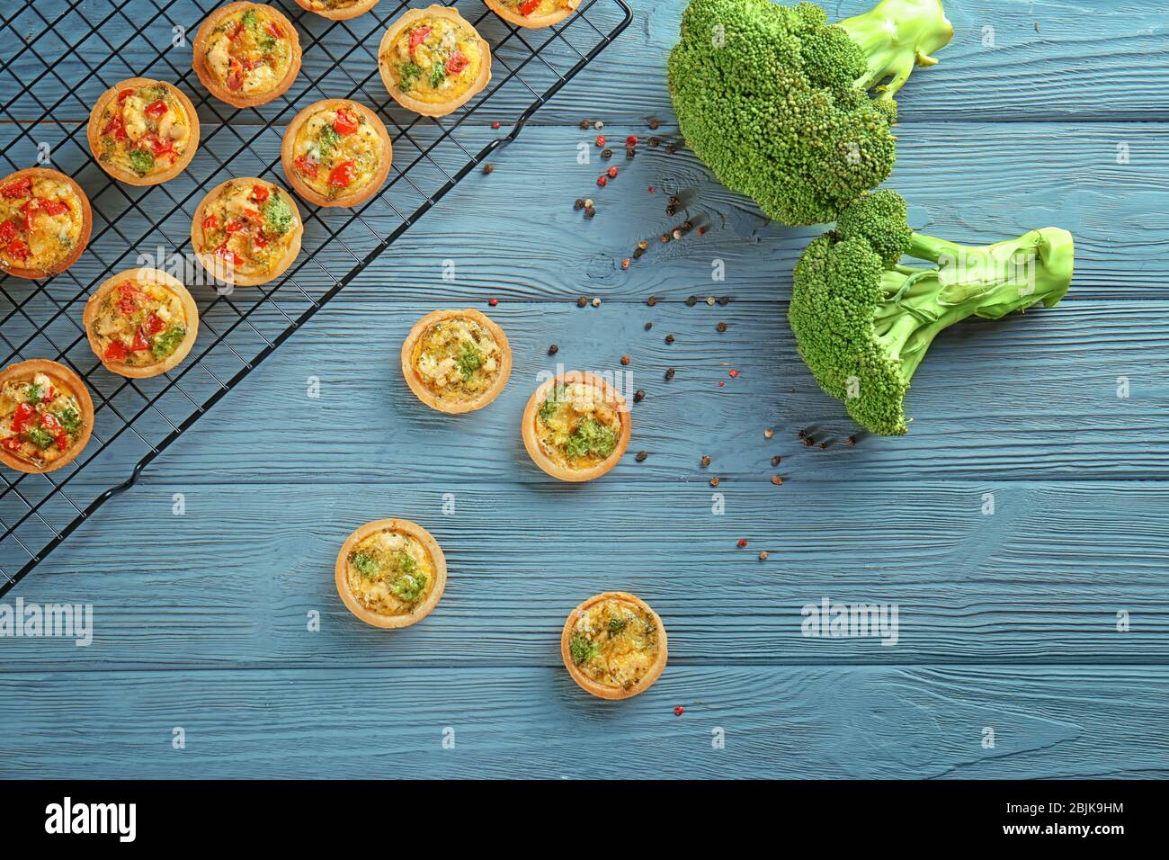 Composition with broccoli quiche tartlets on table Stock Photo