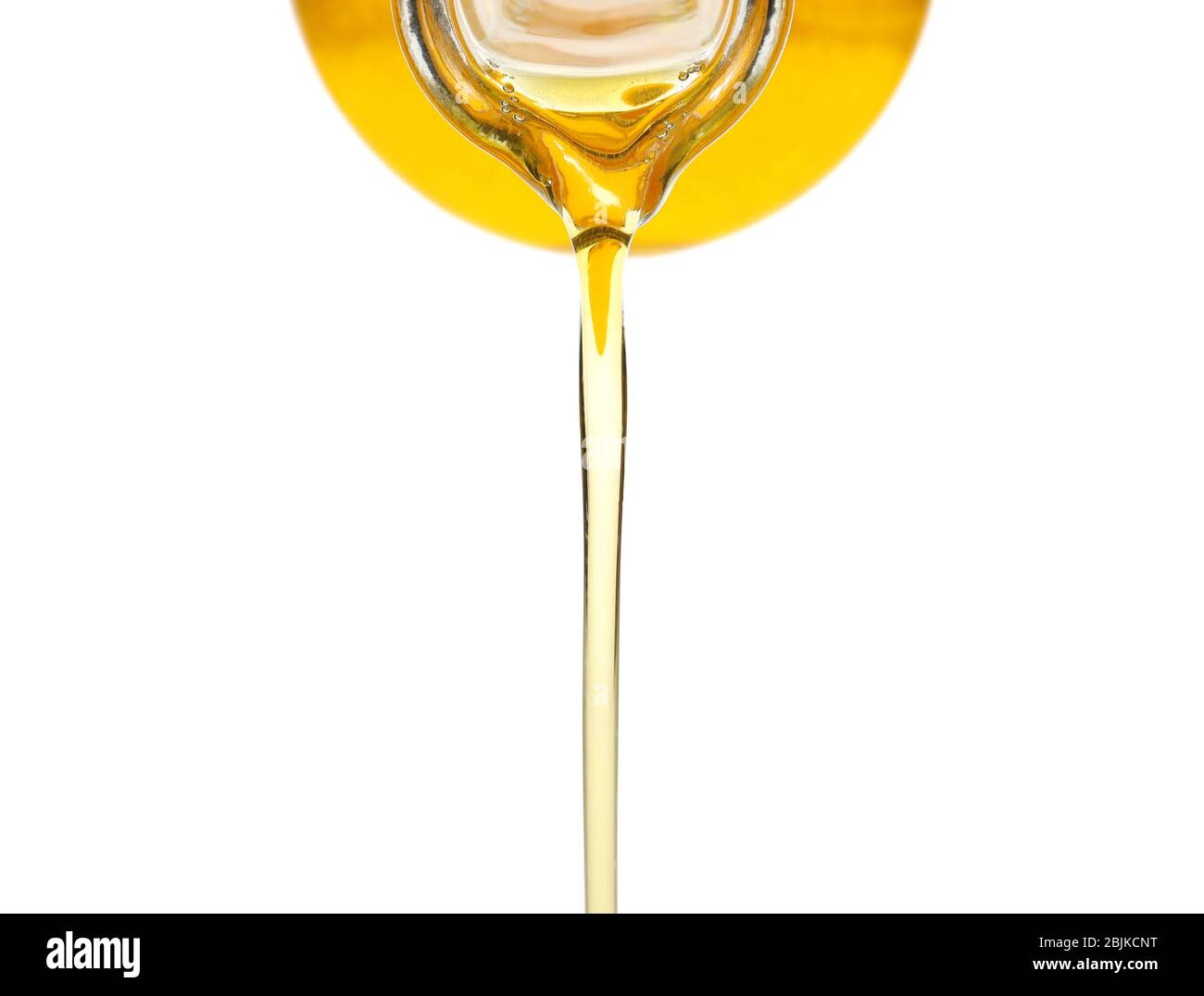Pouring cooking oil from pitcher, on white background Stock Photo - Alamy