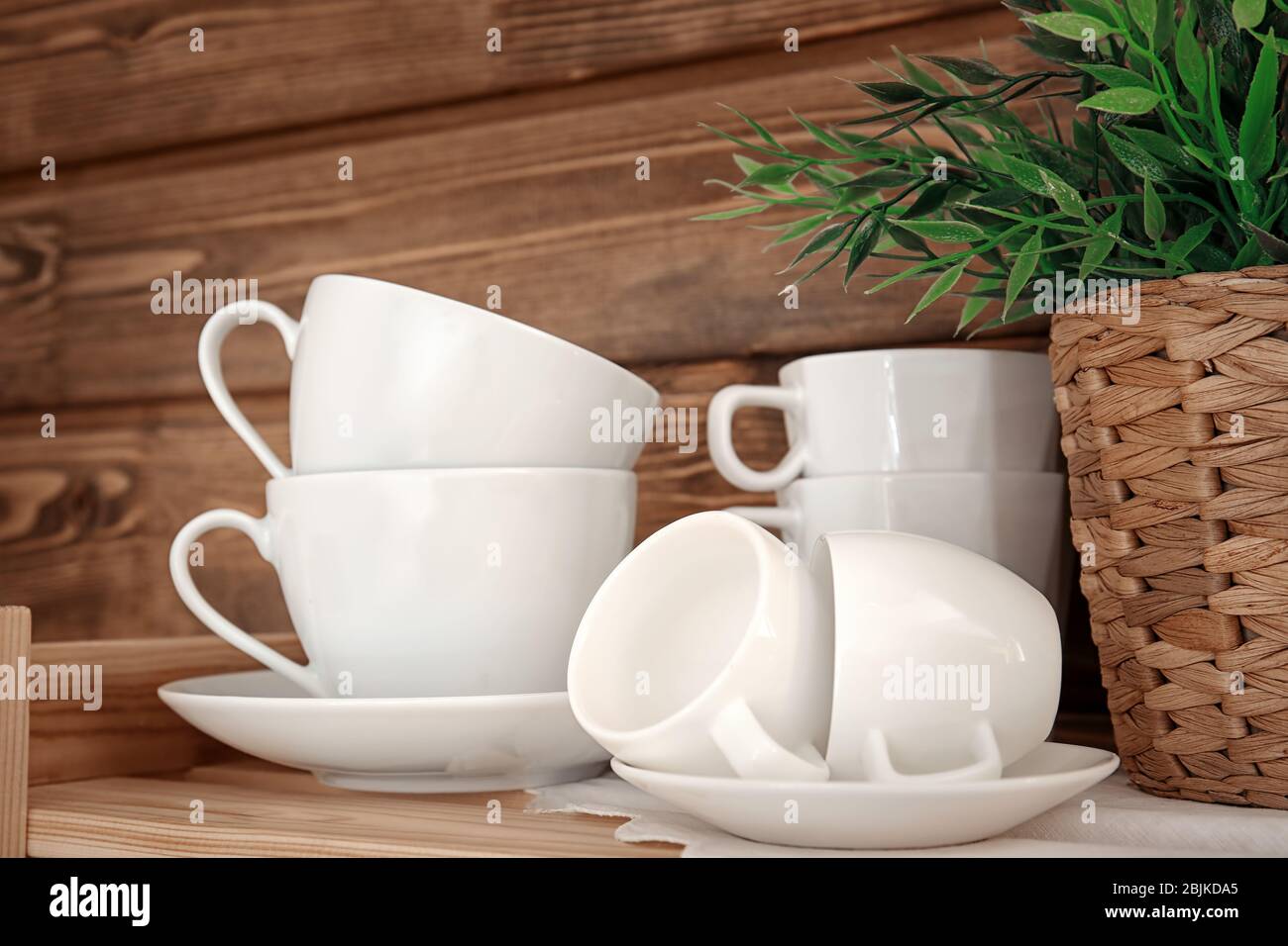 Clean cups on wooden shelf Stock Photo