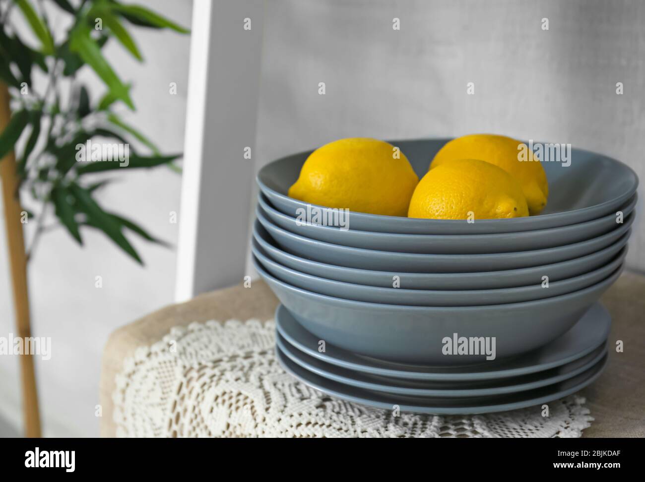 Grey bowls and plates on shelf Stock Photo