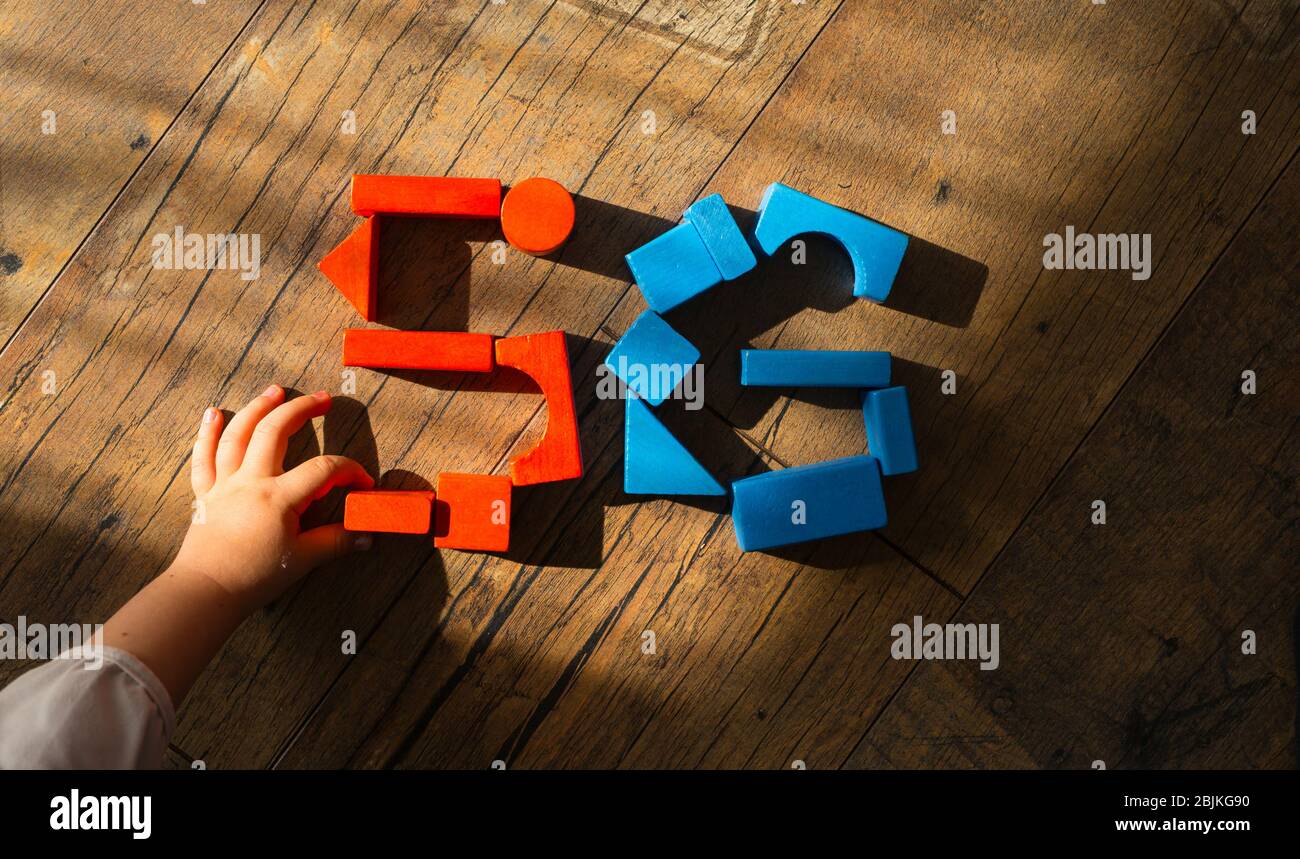 5G network. Kid's hand puts out the sign from wooden cubes. Global telecommunication development. Stock Photo