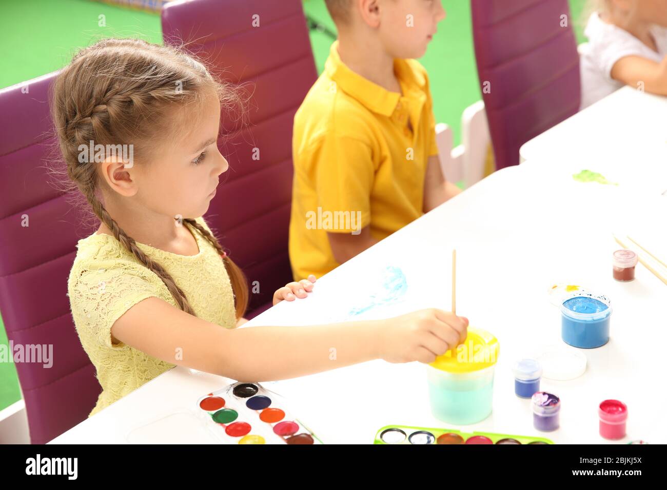 Little children at painting lesson in classroom Stock Photo