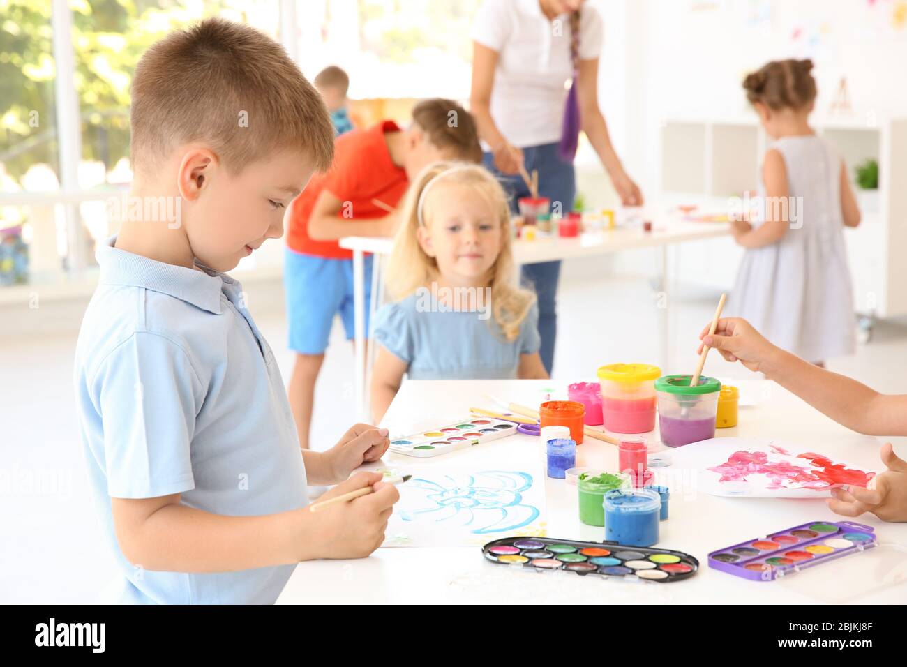 Little boy at painting lesson in classroom Stock Photo