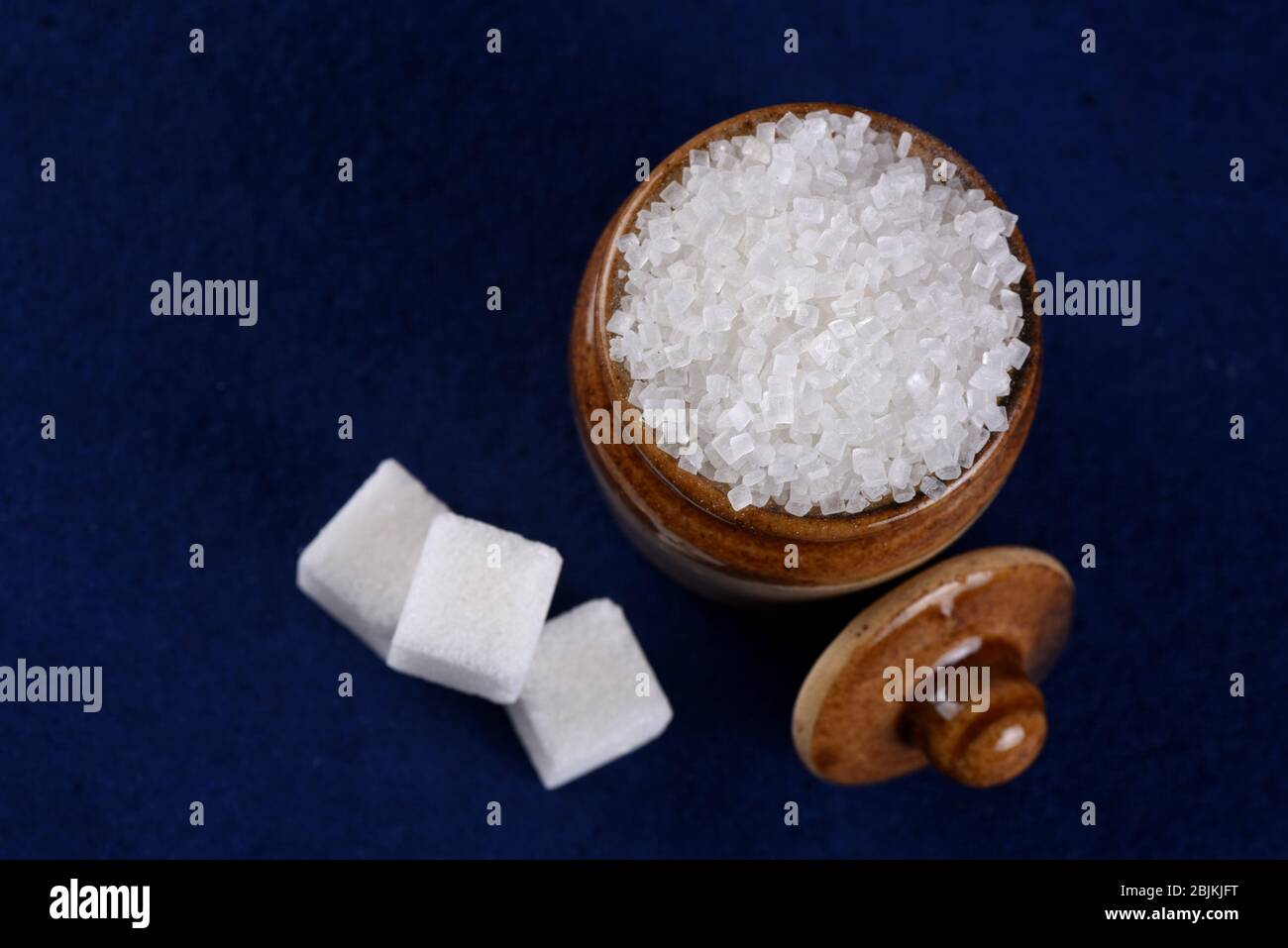 Sugar. white granulated sugar and refined sugar on a blue background. Stock Photo