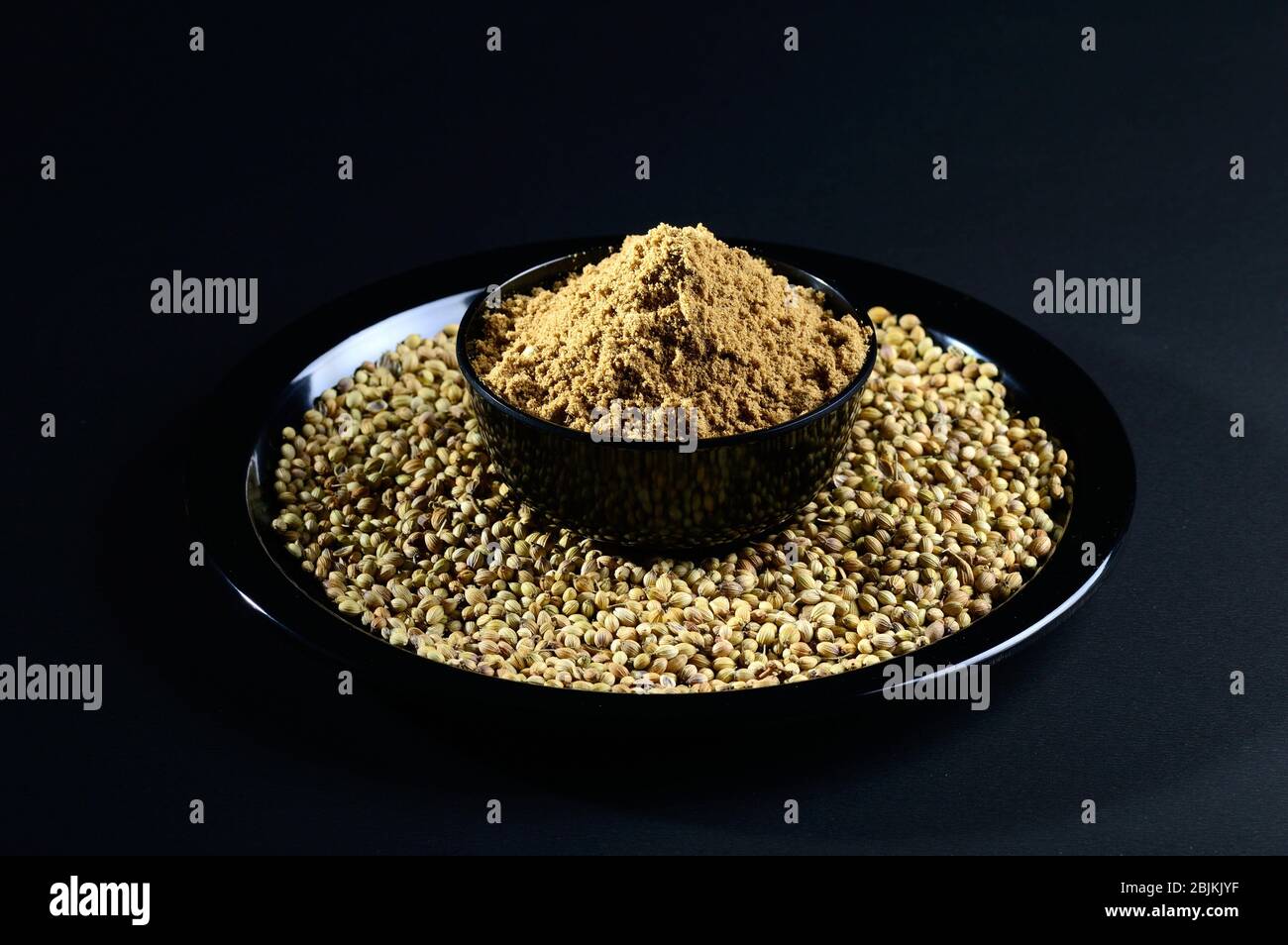 Coriander seeds and Powder on black background Stock Photo Alamy