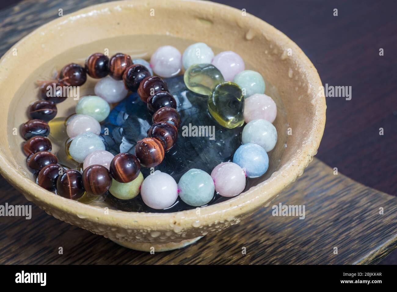 Cleansing, recharge crystals in rainwater using earth nature energy. Stock Photo