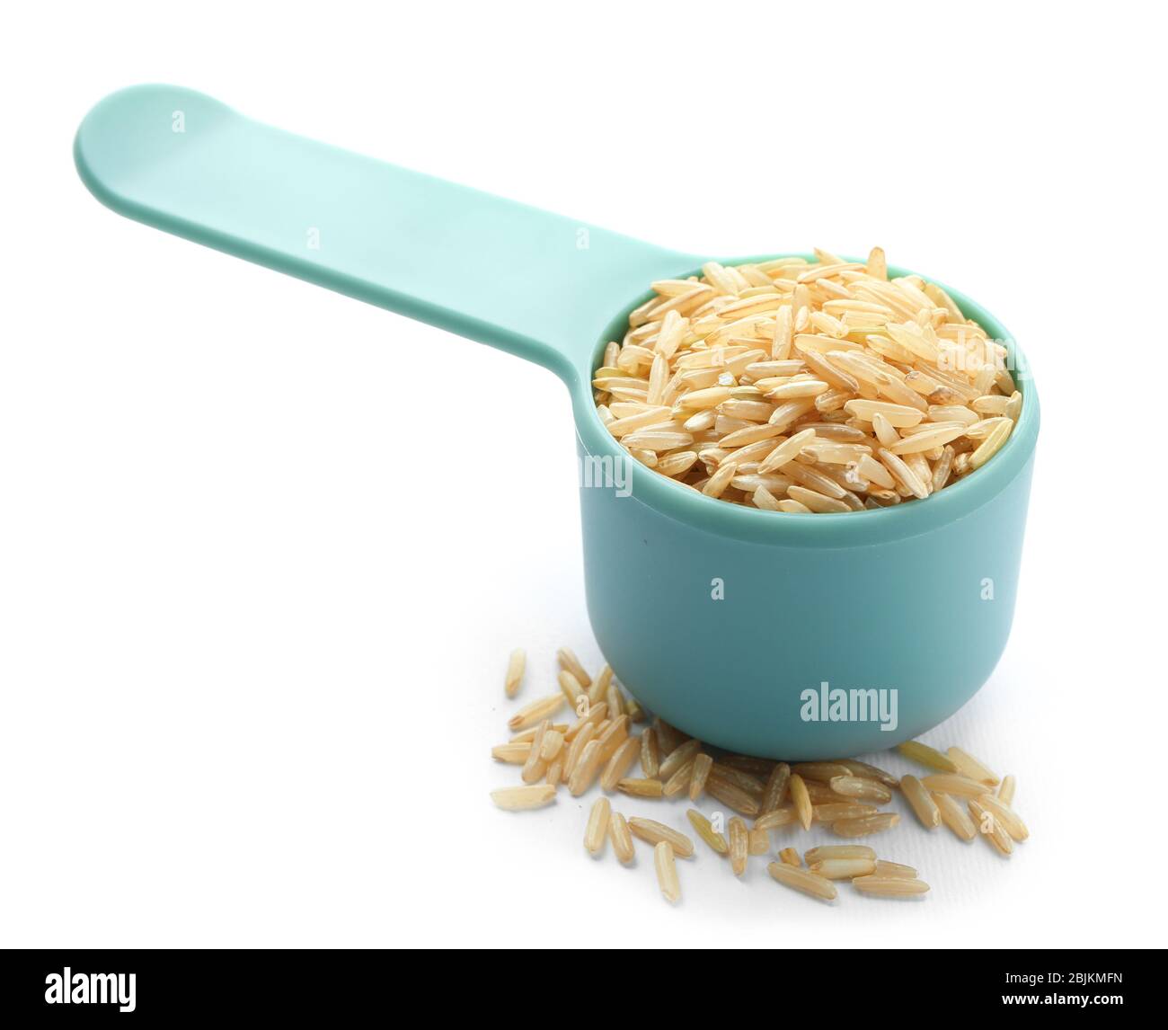 Measure scoop with brown rice on white background Stock Photo Alamy