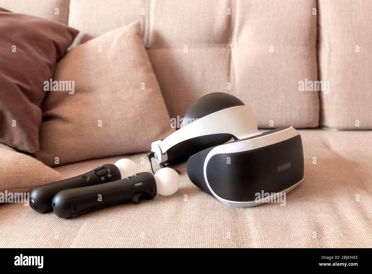 Moscow,Russia - April 12 2020 A playstation 4 VR headset together with a playstation 4 controller and two move controllers on a sofa, ready to start g Stock Photo