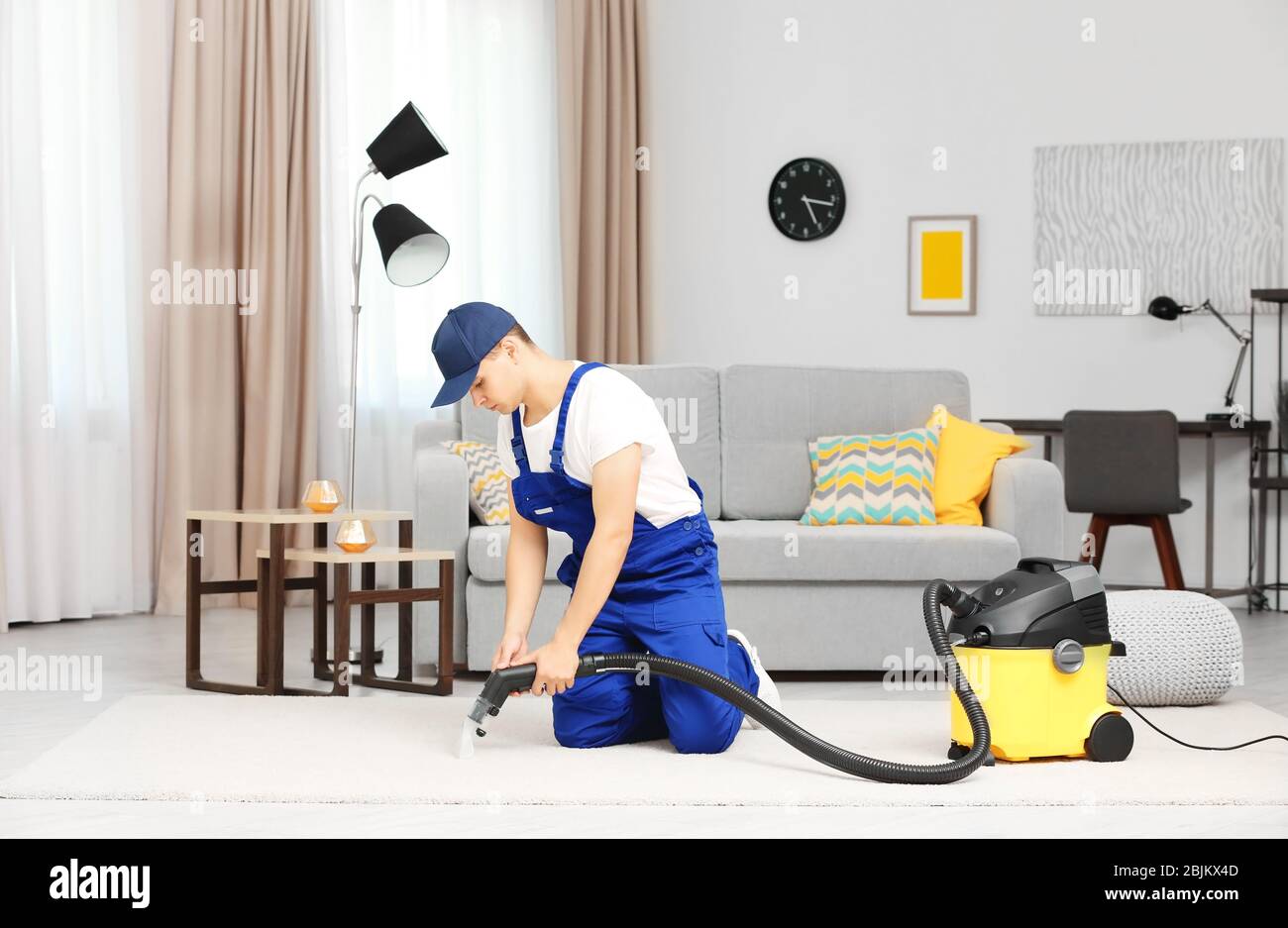 Man using steam vapor cleaner in living room Stock Photo - Alamy