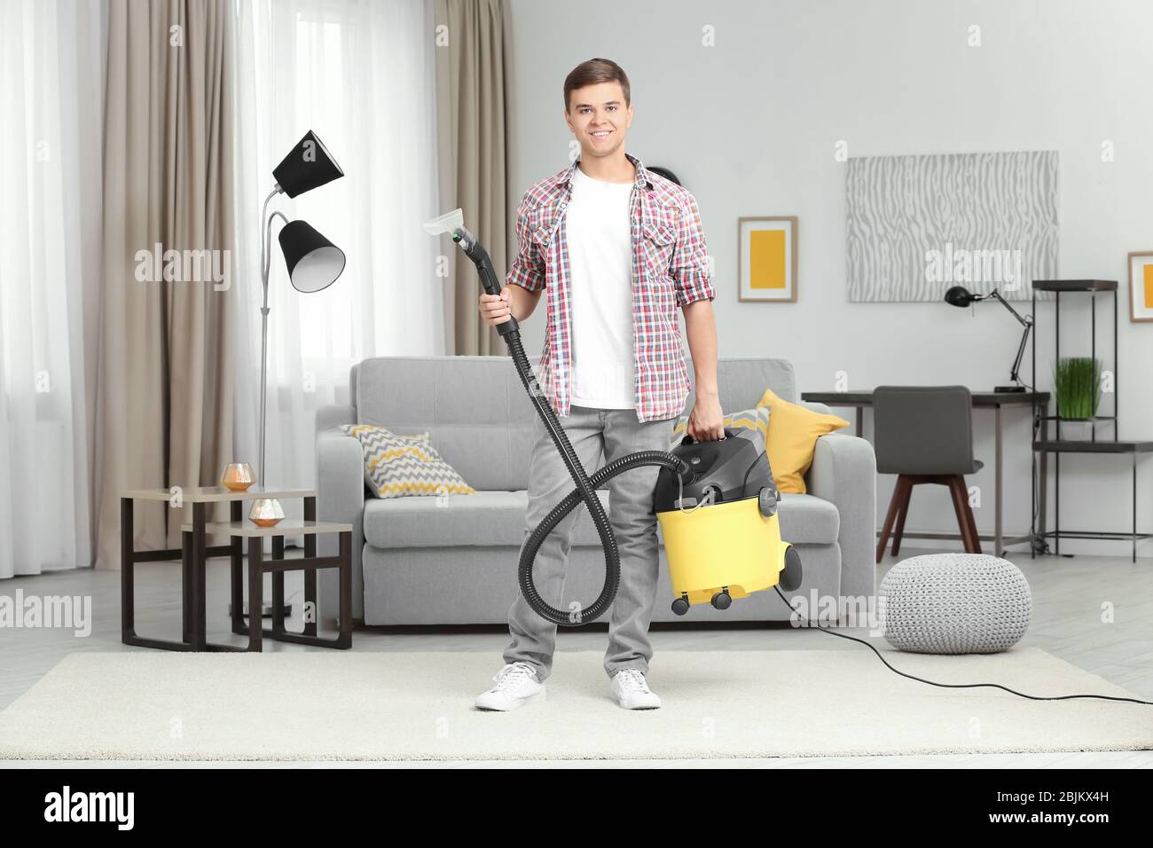 Man with steam vapor cleaner in living room Stock Photo - Alamy