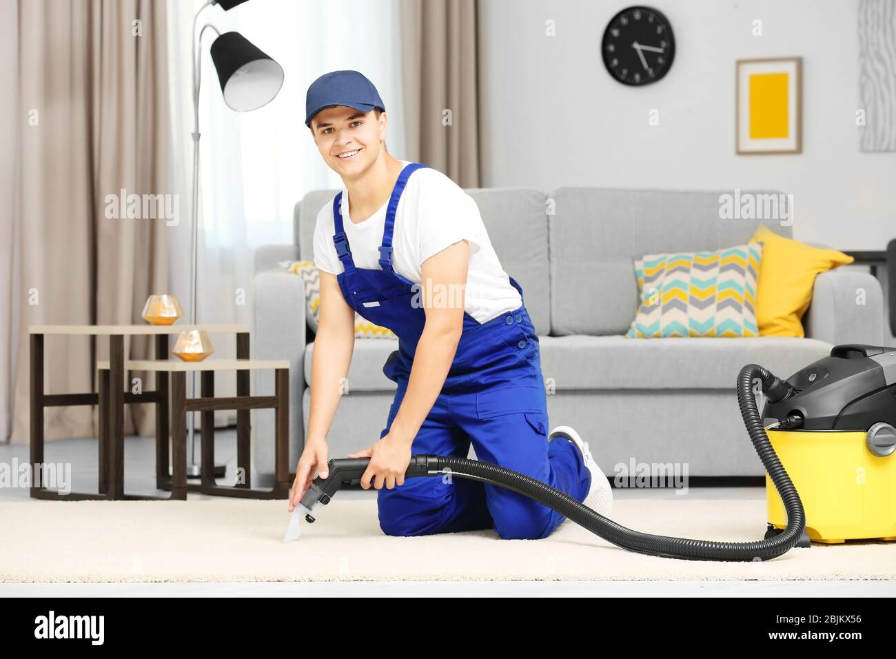 Man using steam vapor cleaner in living room Stock Photo - Alamy
