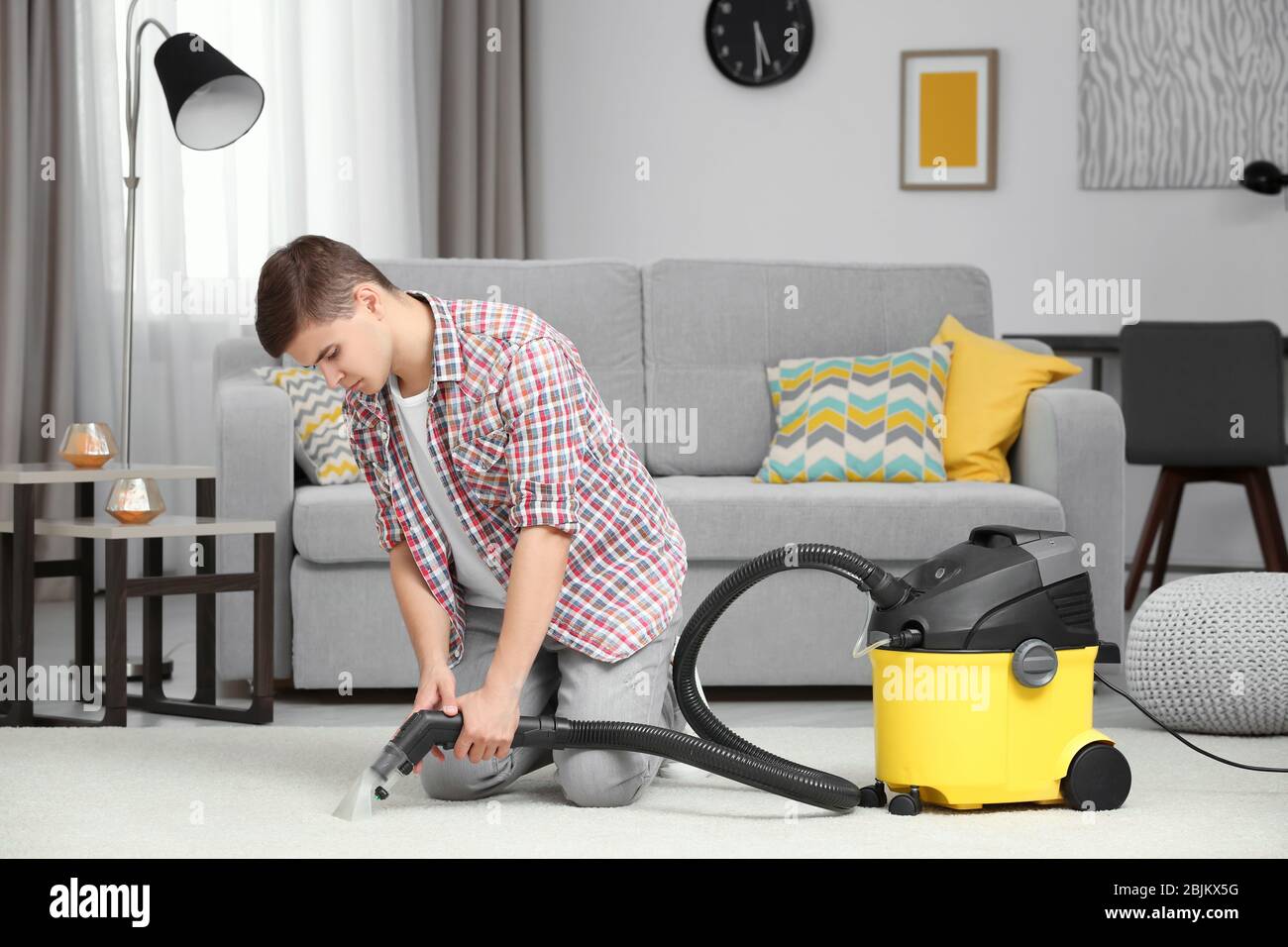 Man using steam vapor cleaner in living room Stock Photo - Alamy