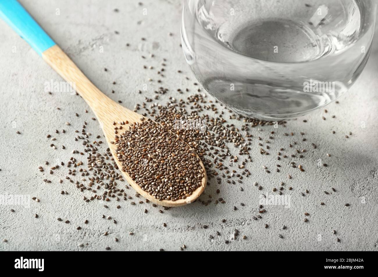 Spoon With Chia Seeds And Glass Of Water On Table Stock Photo Alamy