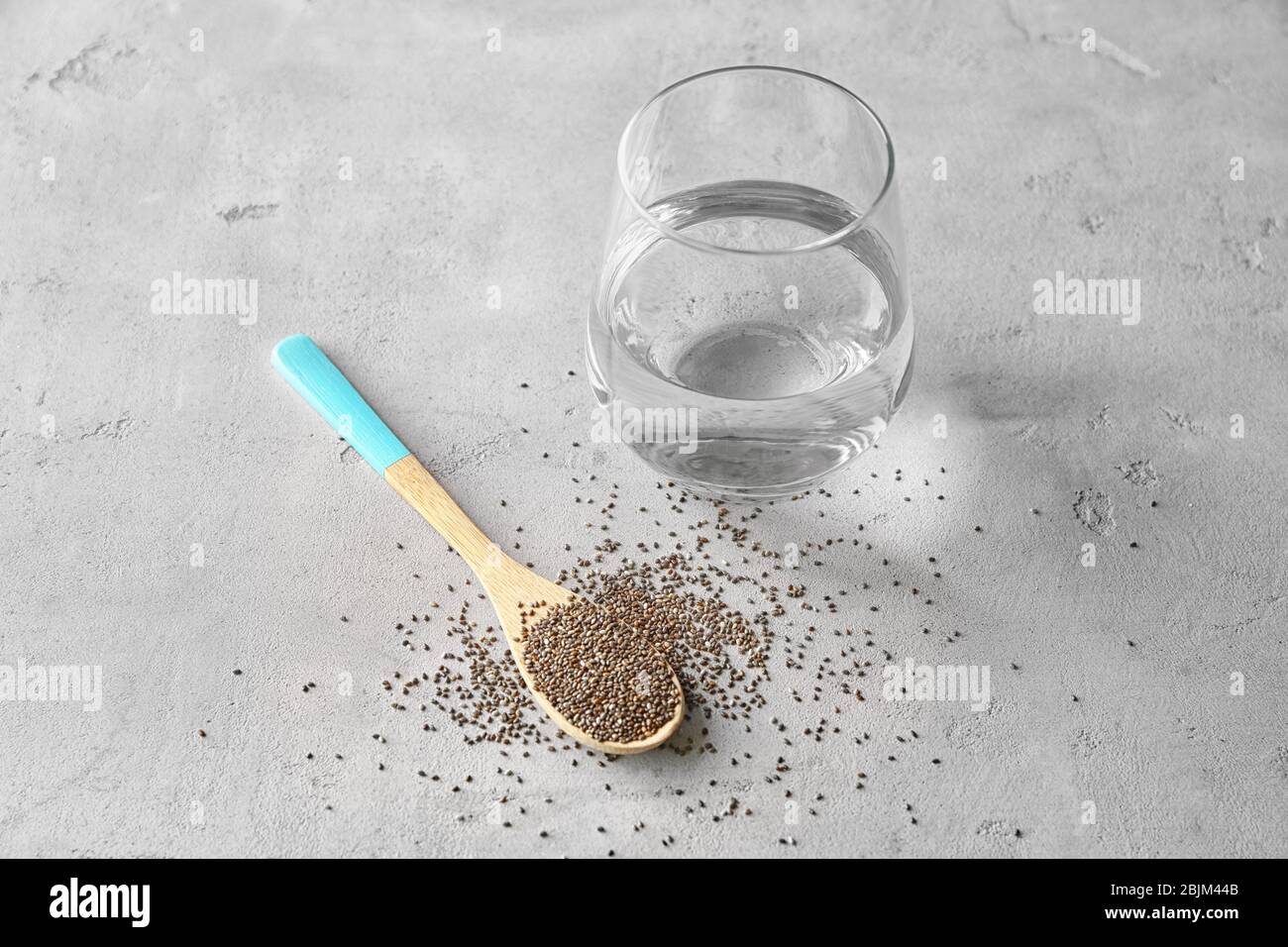 Spoon With Chia Seeds And Glass Of Water On Table Stock Photo Alamy