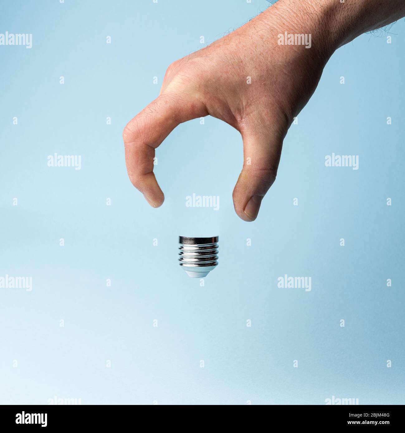 a missing light bulb in the hand Stock Photo