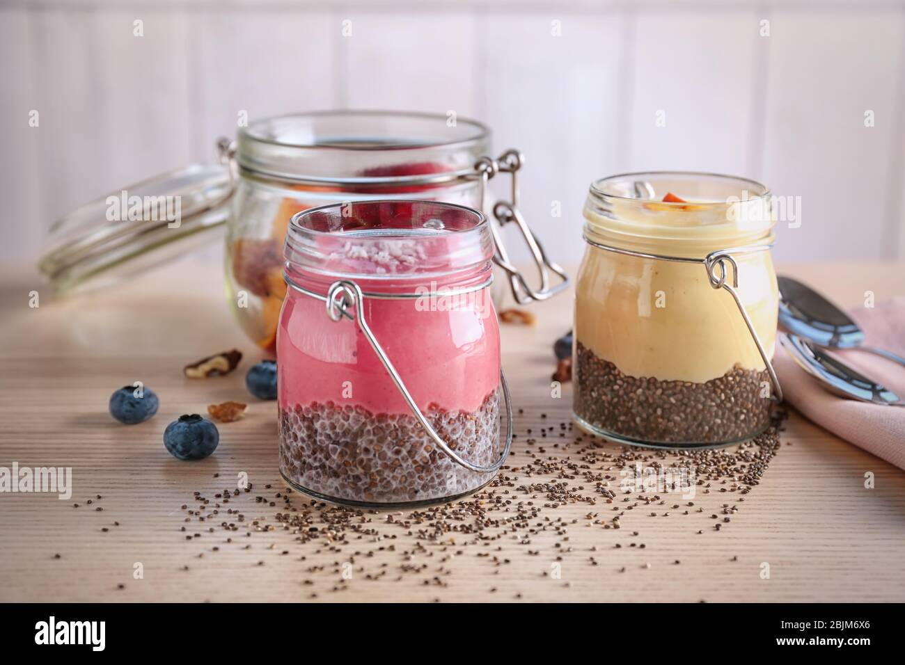 Smoothies with chia seeds in jars on table Stock Photo