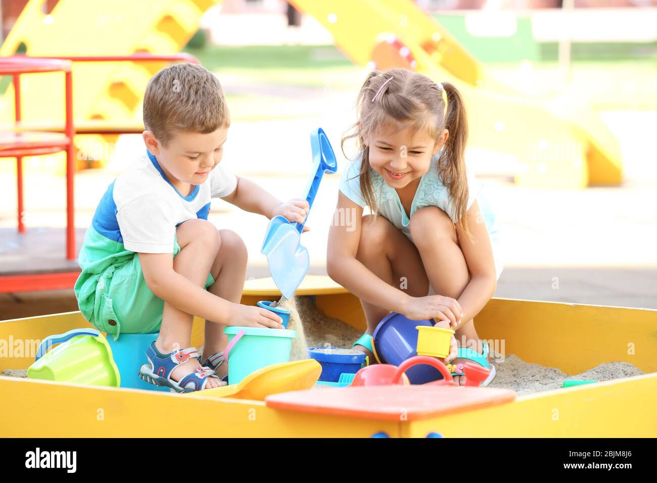 Little children playing with toys in sand box outdoors Stock Photo - Alamy