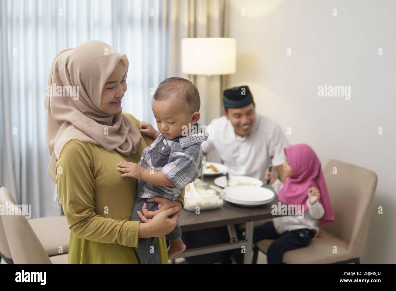 beautiful muslim family having dinner together. breakfasting concept during ramadan kareem Stock Photo