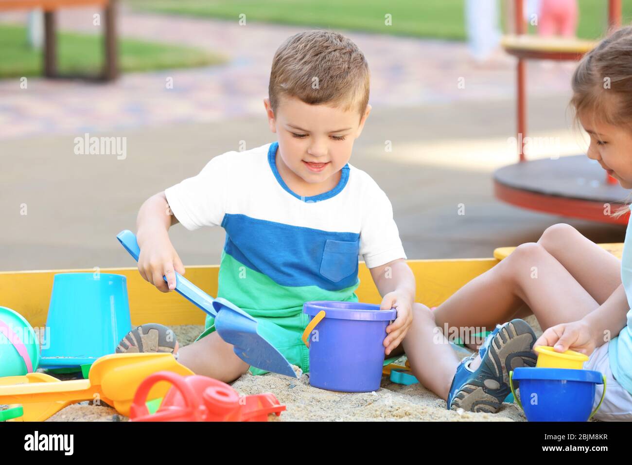 Little children playing with toys in sand box outdoors Stock Photo - Alamy