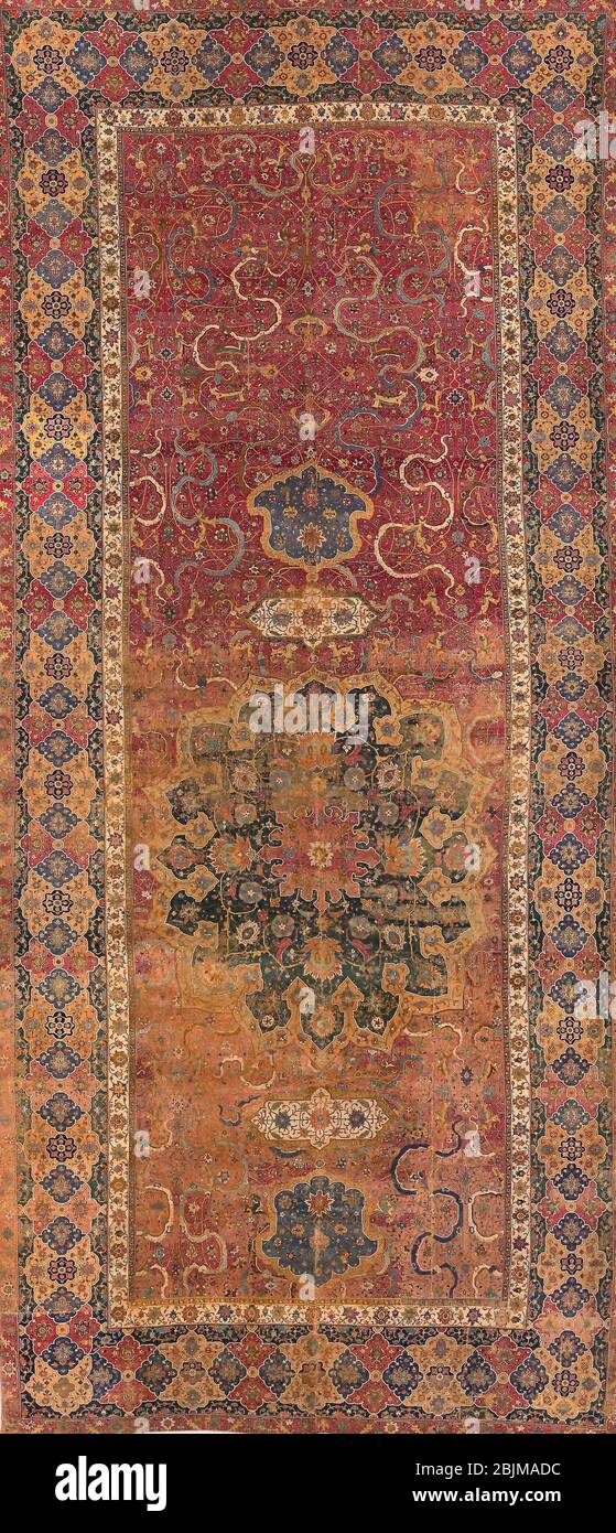 Author: Islamic. Carpet - Early 17th century - Persia, Tabriz. Cotton and wool, plain weave with supplementary wrapping wefts forming cut pile Stock Photo