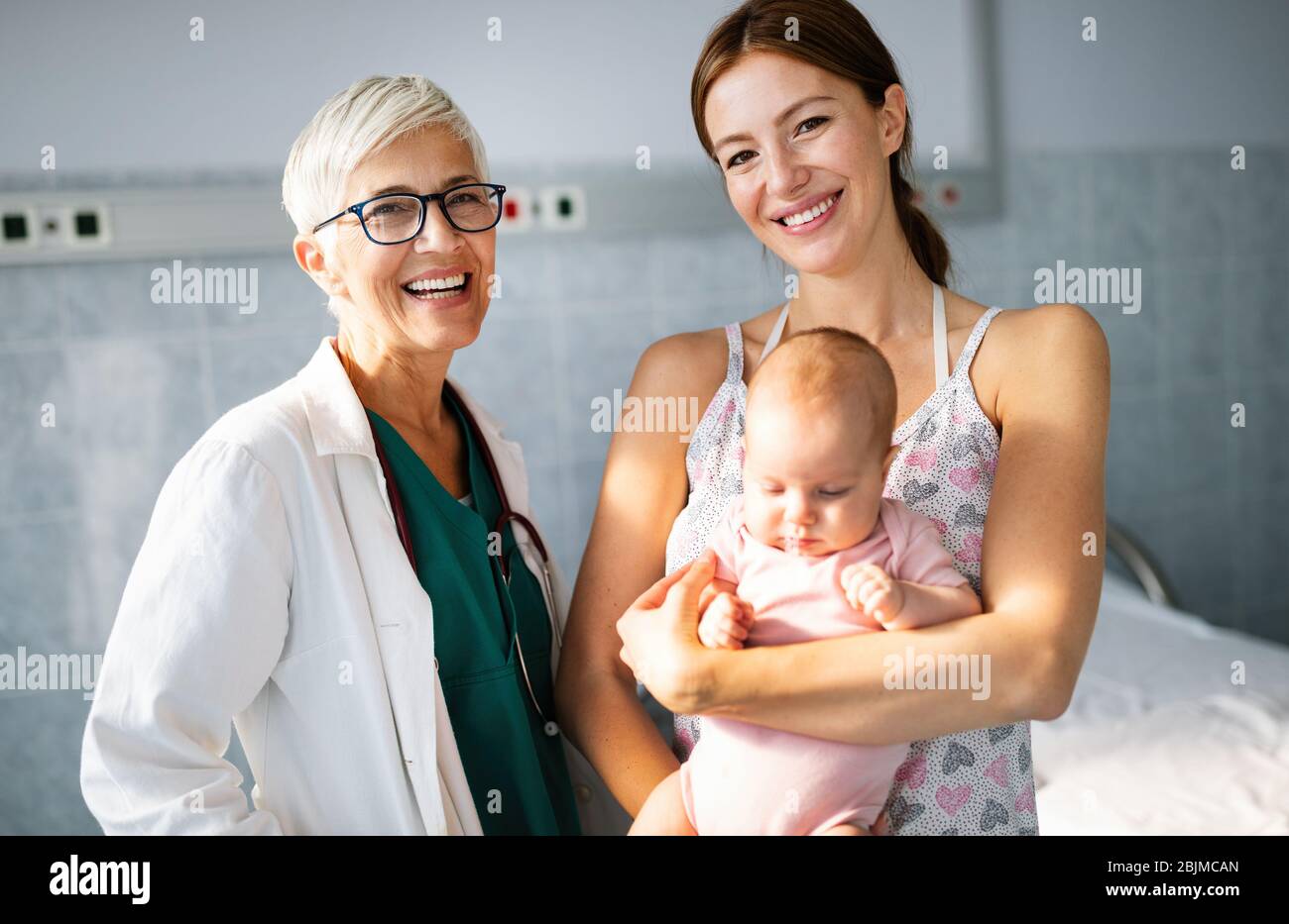 Happy beautiful mother and little baby on medical examination in pediatrician office Stock Photo
