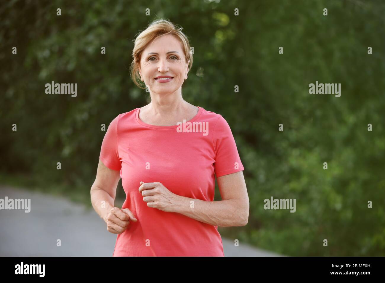 Mature woman running outdoors hi-res stock photography and images - Alamy