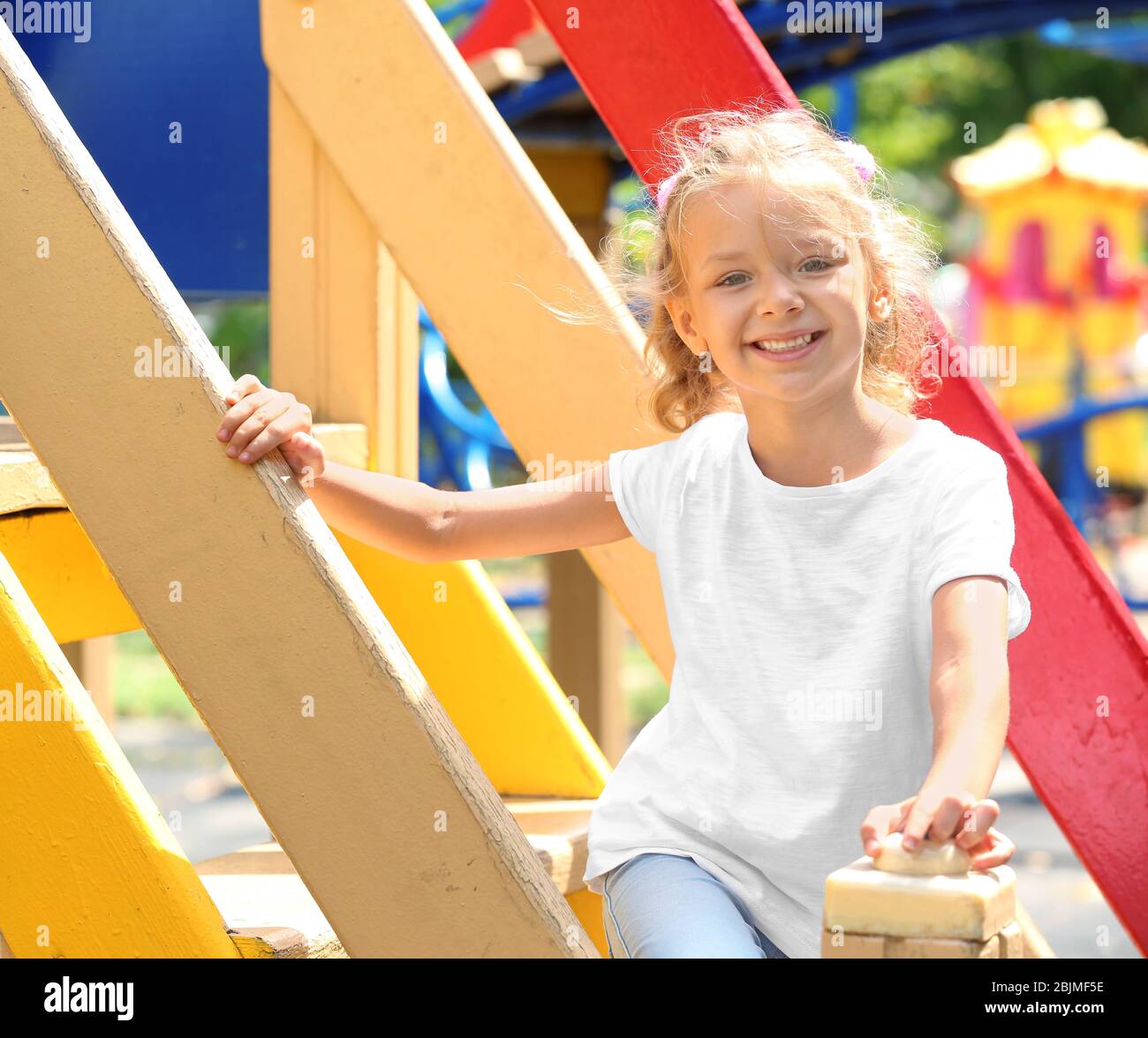 Cute little girl on playground Stock Photo - Alamy