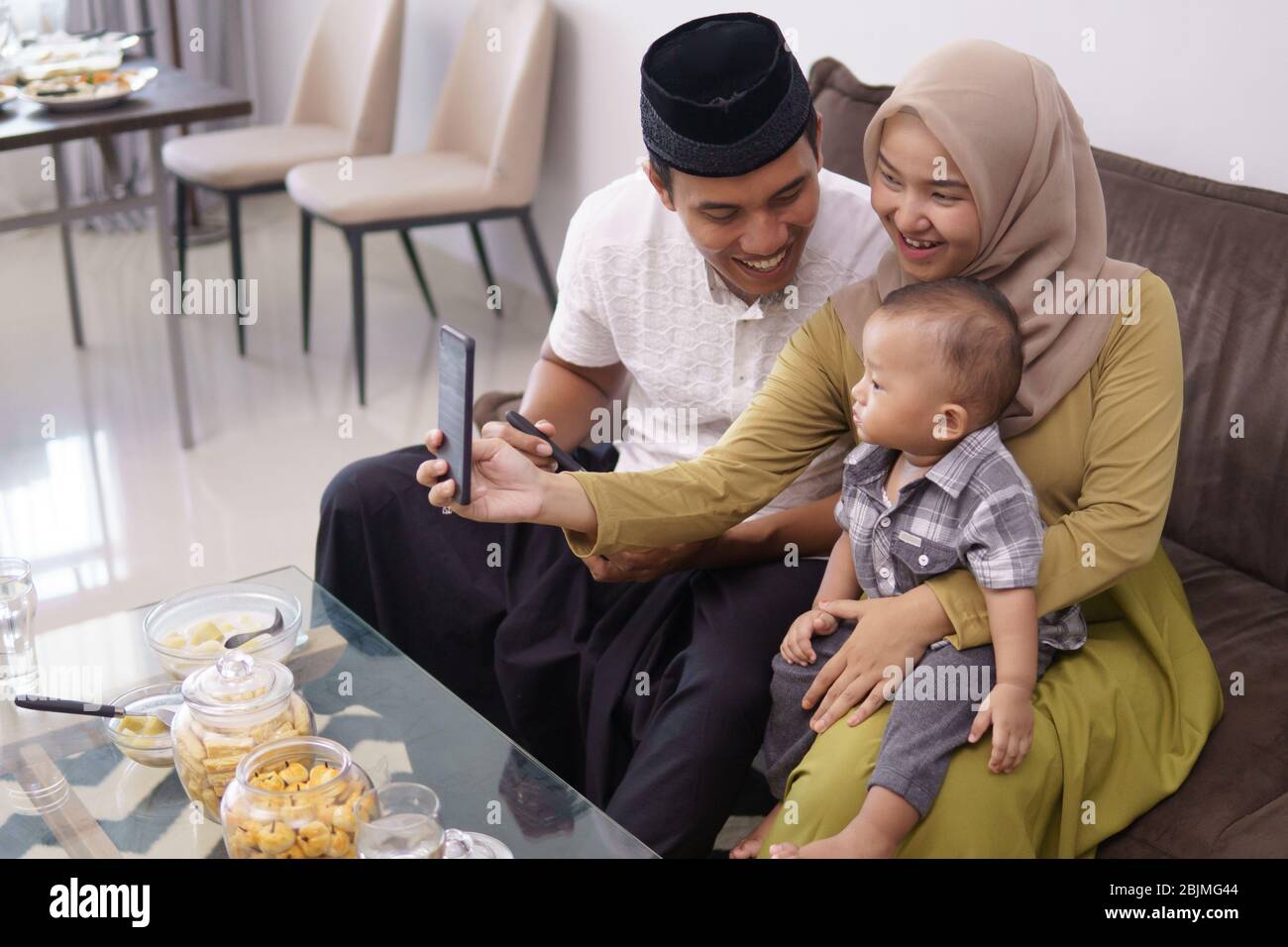 family muslim make a video call with family during ramadan Stock Photo