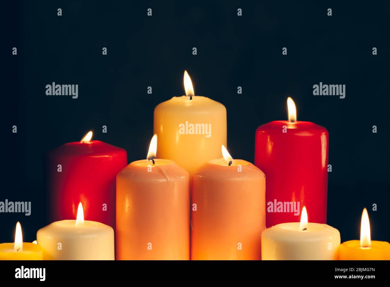 candles burning in darkness over black background. commemoration