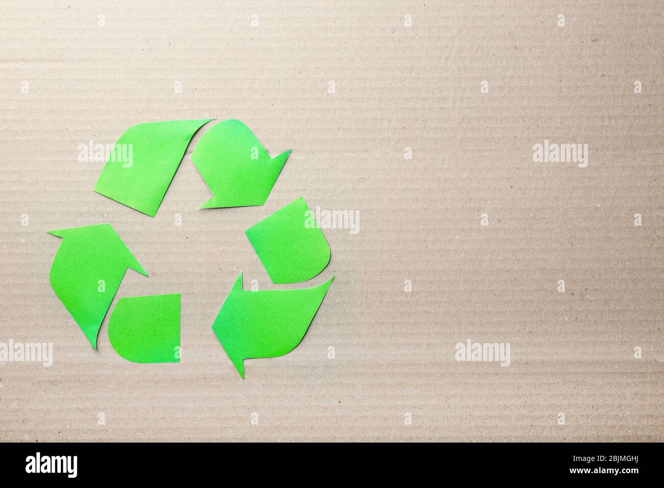 Symbol of recycling on cardboard background Stock Photo - Alamy