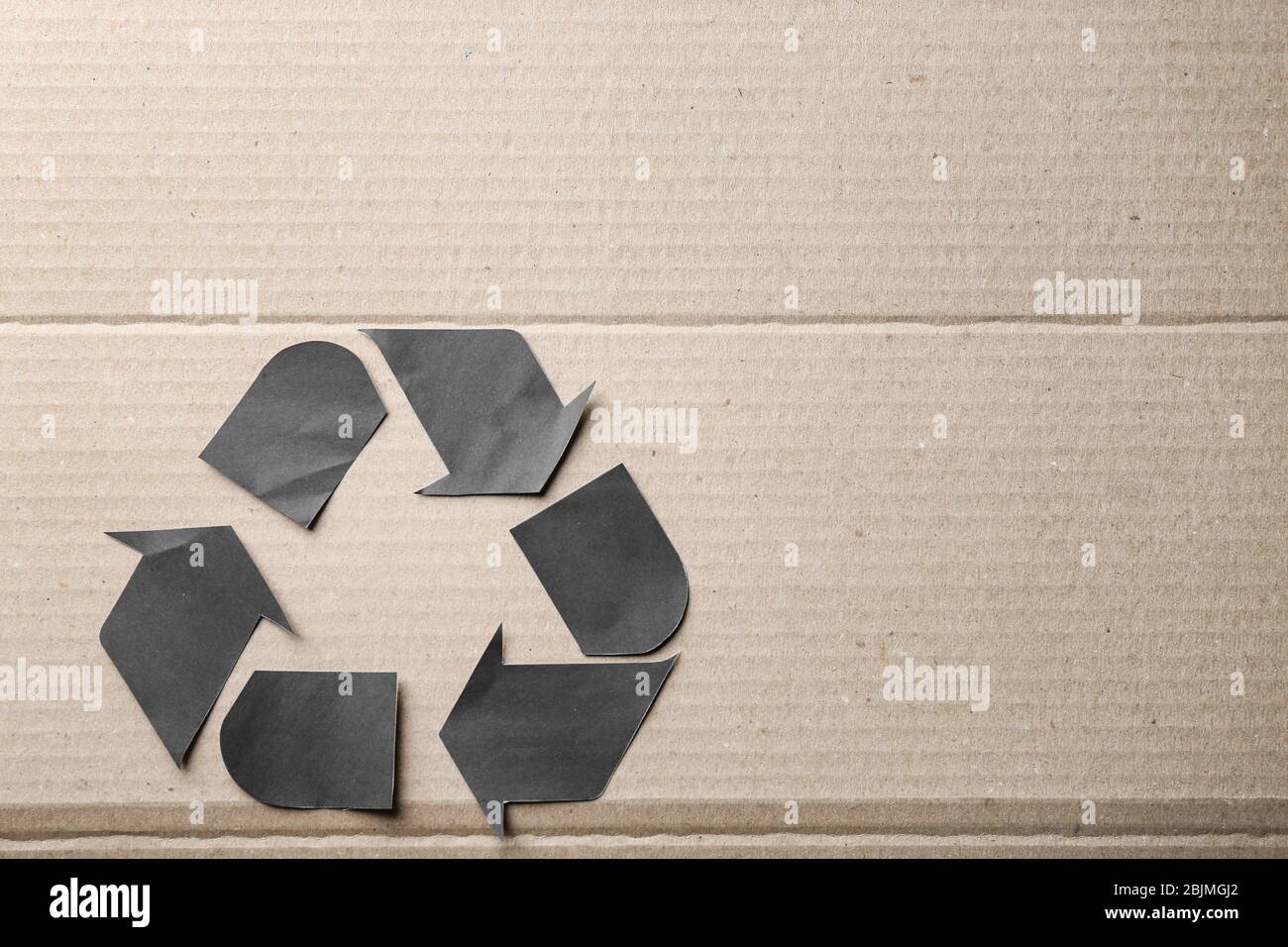 Symbol of recycling on cardboard background Stock Photo - Alamy