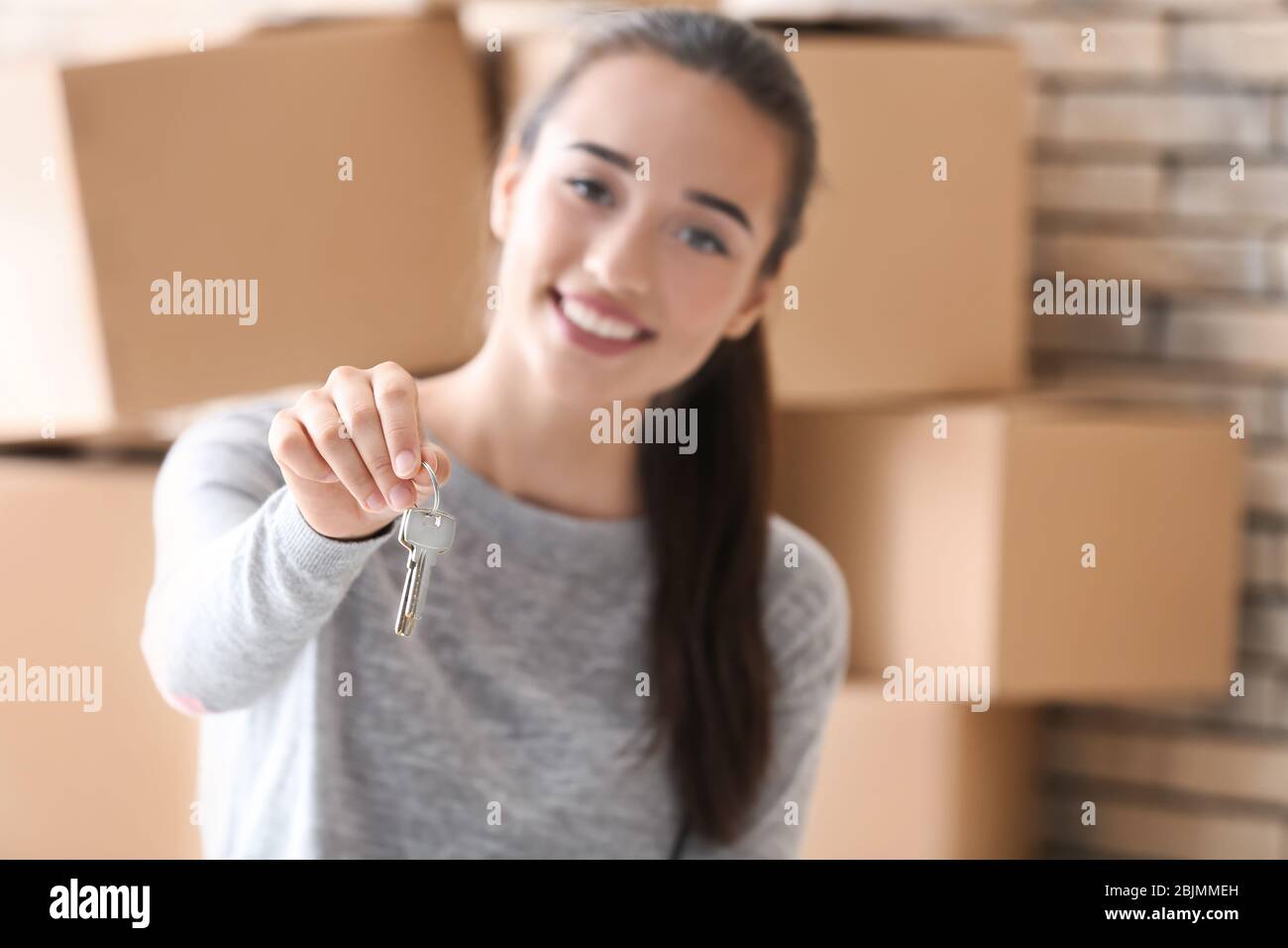 Happy young woman holding keys hi-res stock photography and images - Alamy