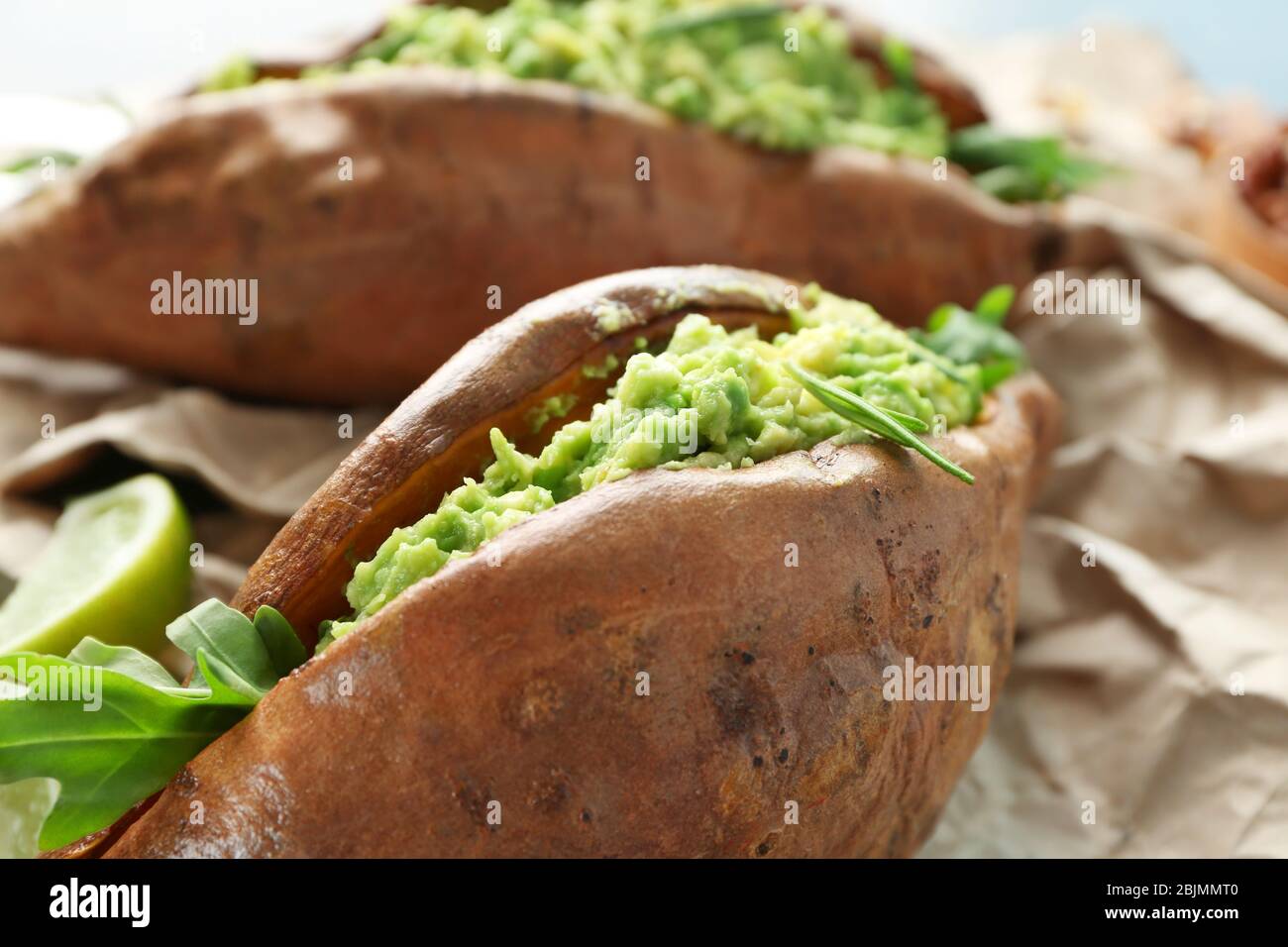 Baked sweet potato stuffed with guacamole, closeup Stock Photo Alamy
