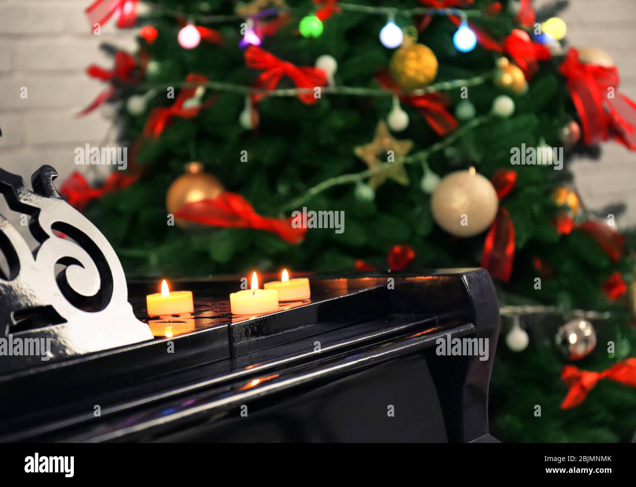 Candles on piano in room. Christmas music concept Stock Photo Alamy