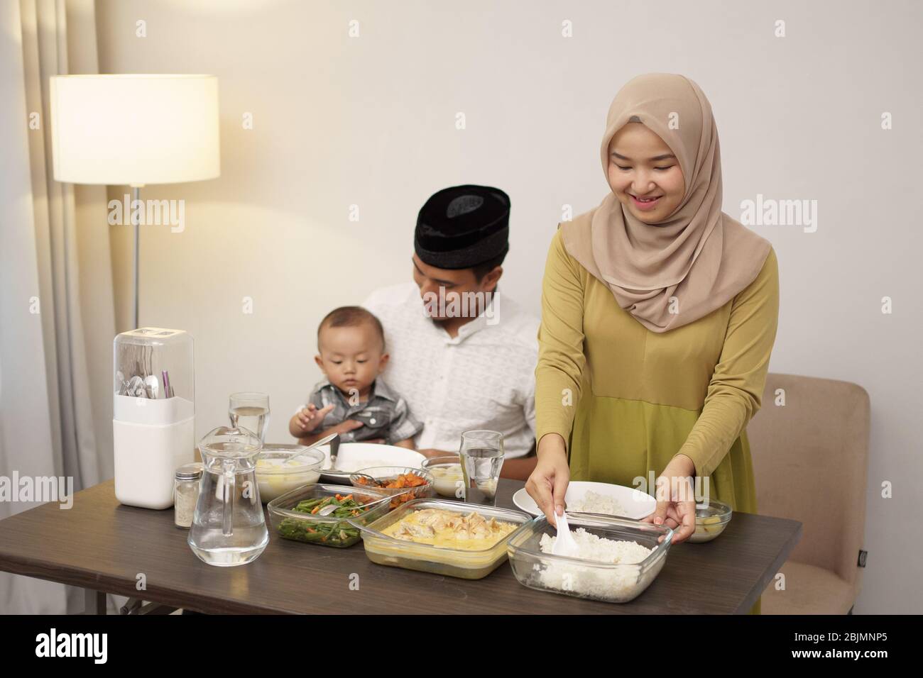 muslim family with toddler breakfasting during ramadan kareem at home together Stock Photo