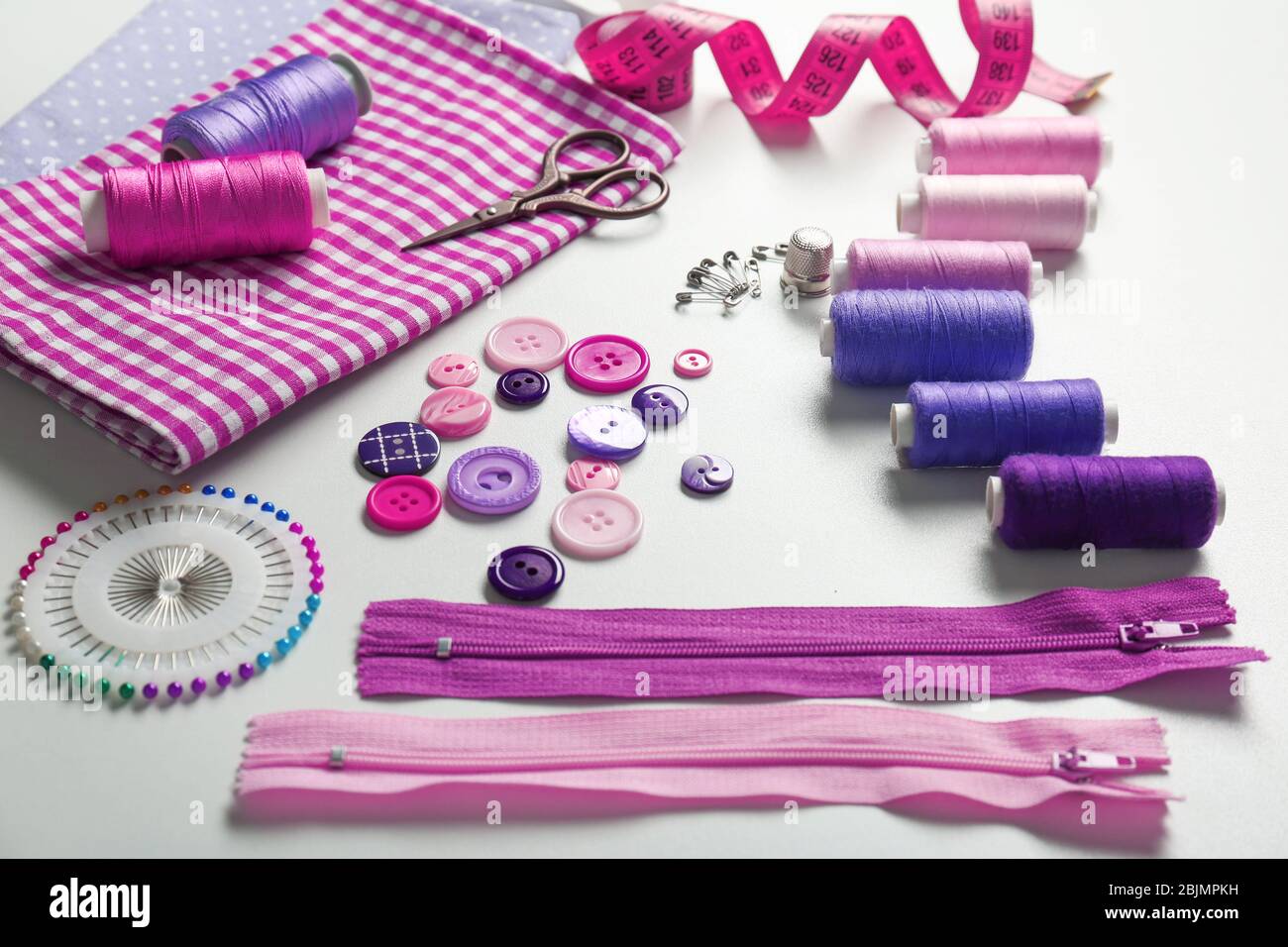 Composition with threads and sewing accessories on white background Stock Photo