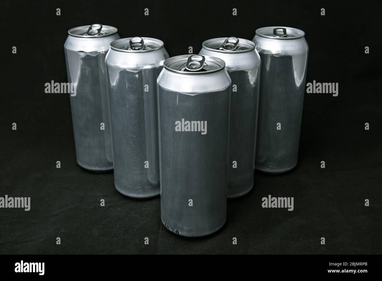 Simple 5 aluminium cans. Scratched, on black background. Pyramide Stock Photo