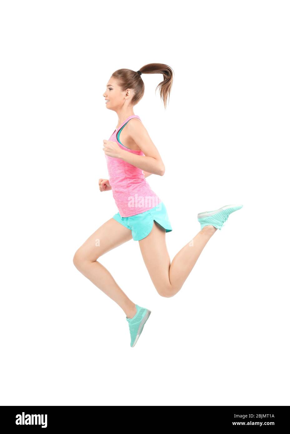Young sporty woman jumping on white background Stock Photo - Alamy