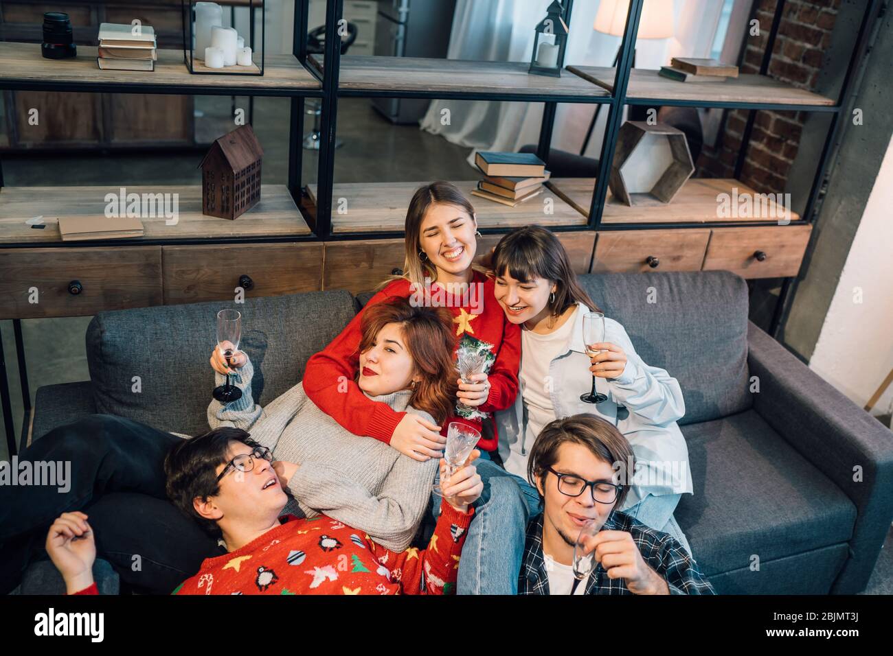 Group friends talking sitting in a couch in the living room Stock Photo ...