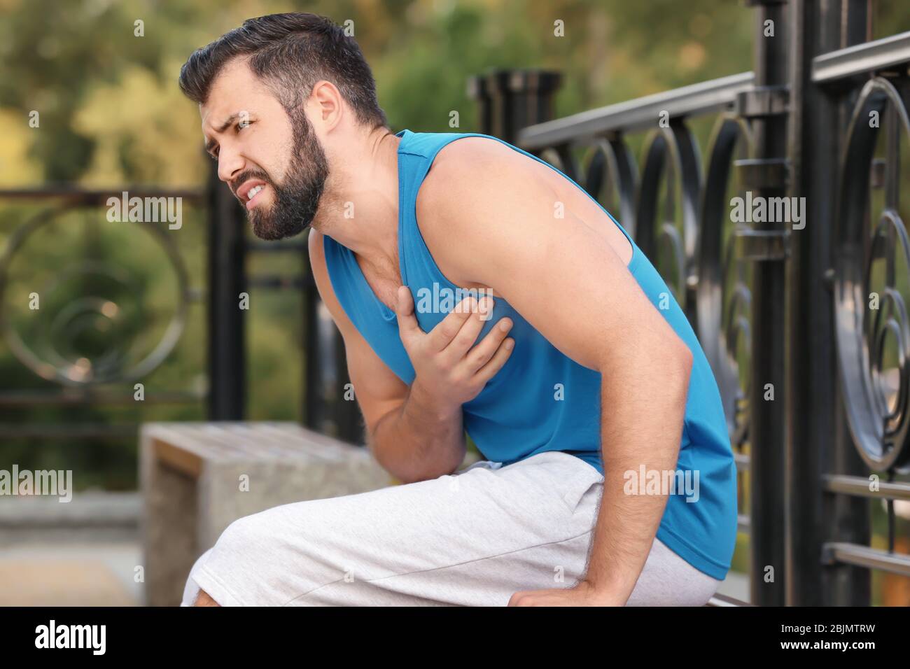 Suffering coronary angina heart attack emergency hires stock