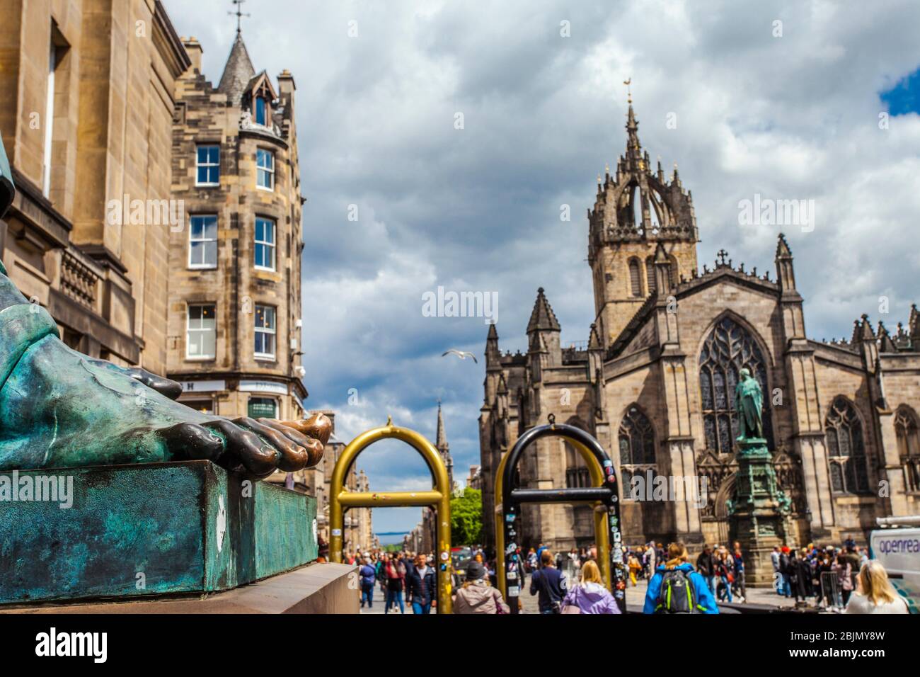 Foot of David Hume statue and St Giles´ Cathedral, or the High Kirk of Edinburgh, Royal Mile, High Street, Old Town, Edinburgh, Scotland, United Stock Photo