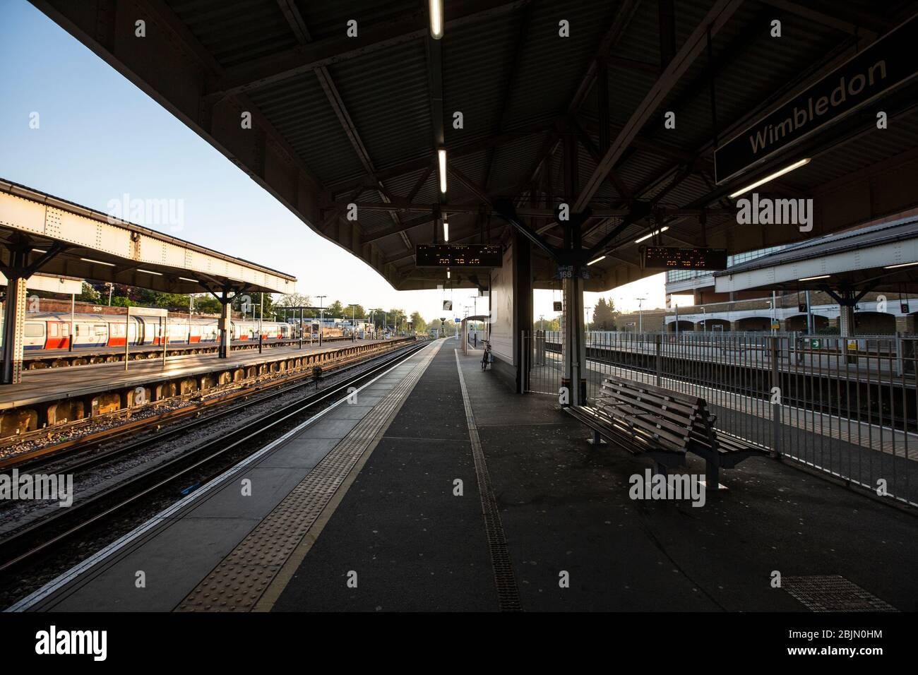 A completely abandoned Wimbledon station platform early in the morning in the Southwest of London during the coronavirus COVID-19 lockdown, UK Stock Photo