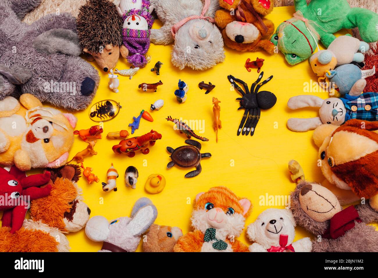 children's soft toys for developing games on a yellow background Stock Photo