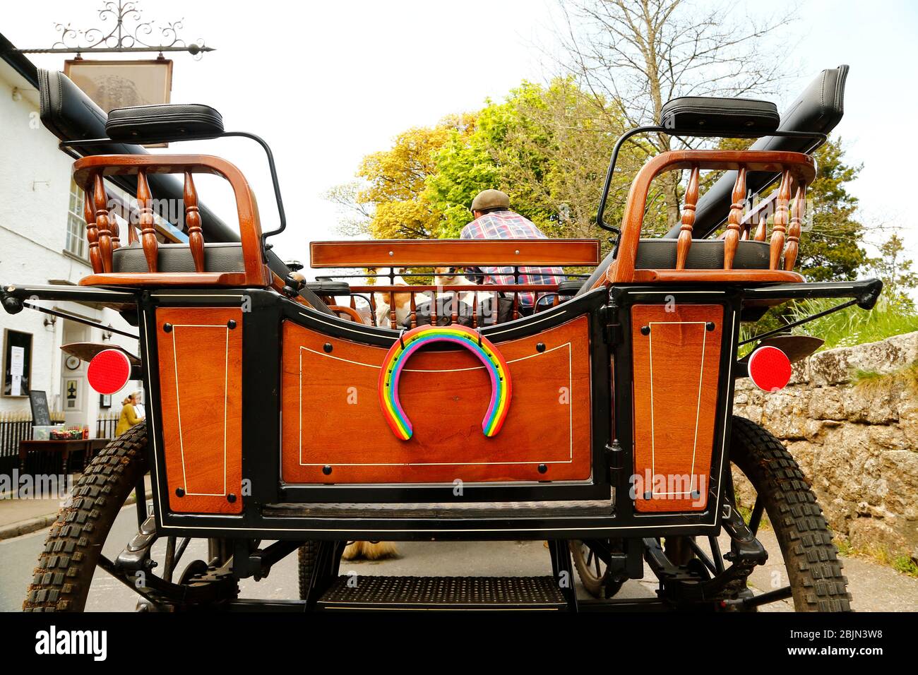 Traditional Shire horses & carriage delivering shopping to a local