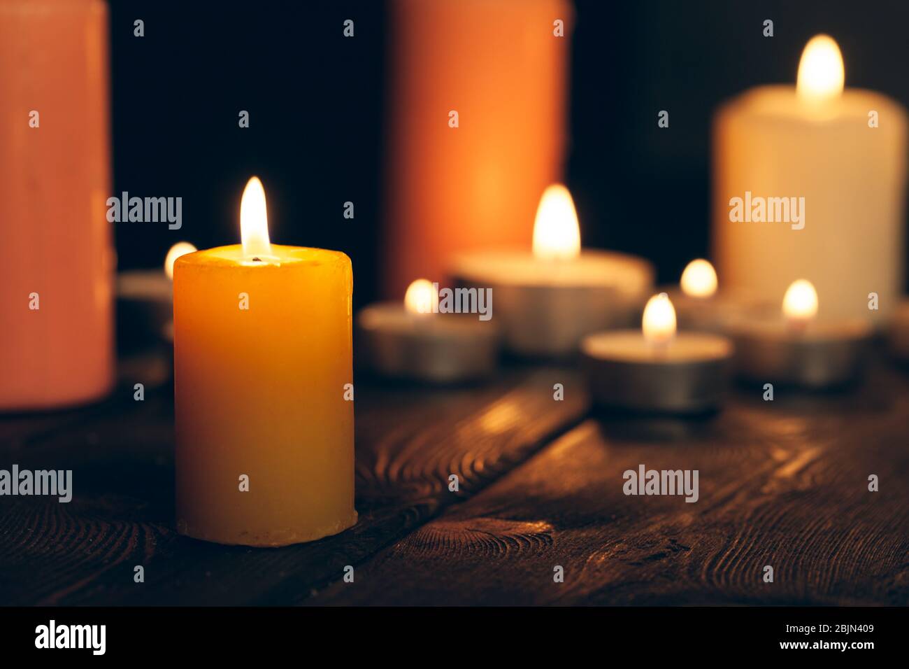candles burning in darkness over black background. commemoration