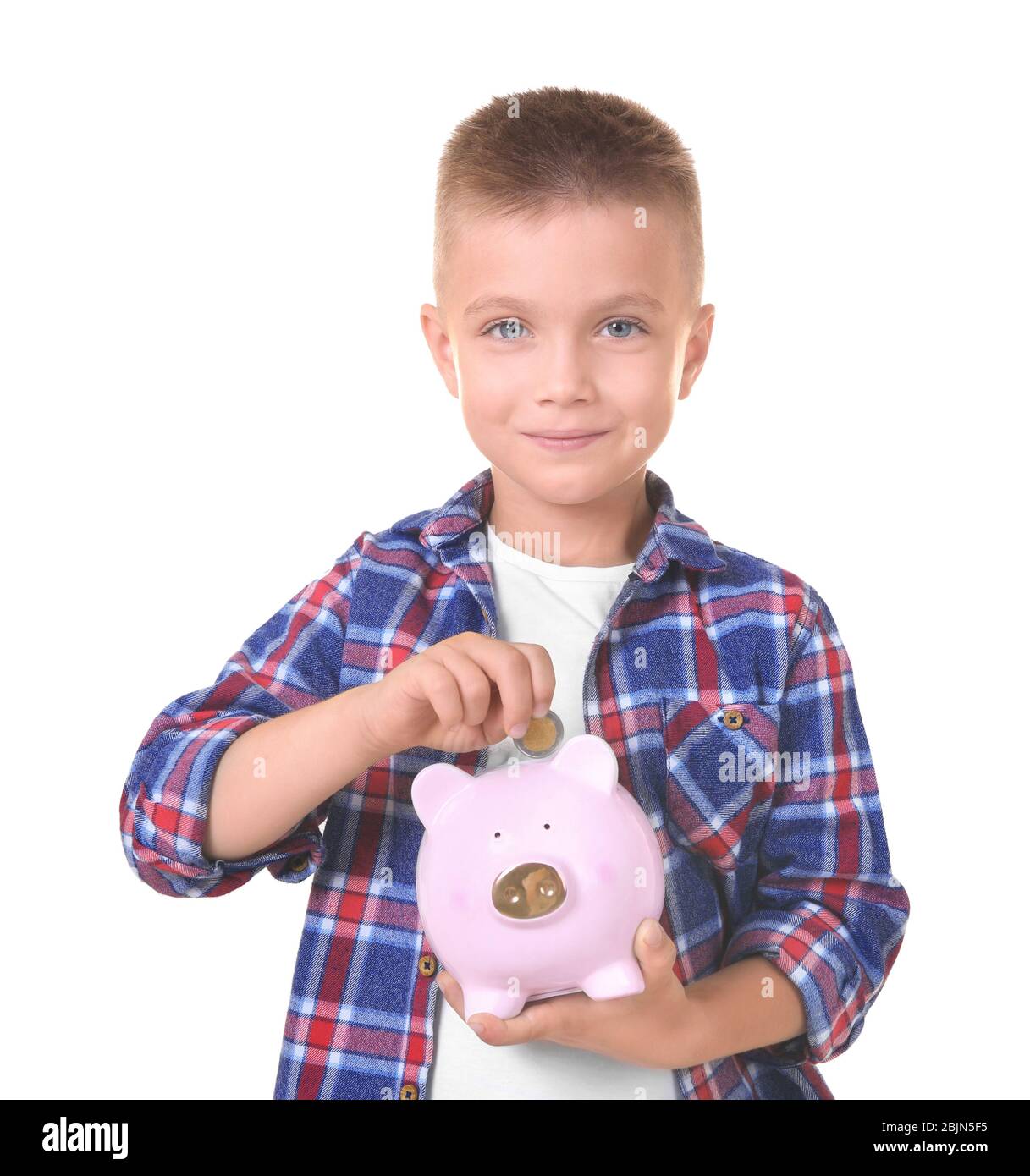 Cute little boy putting coin into piggy bank on white background Stock ...