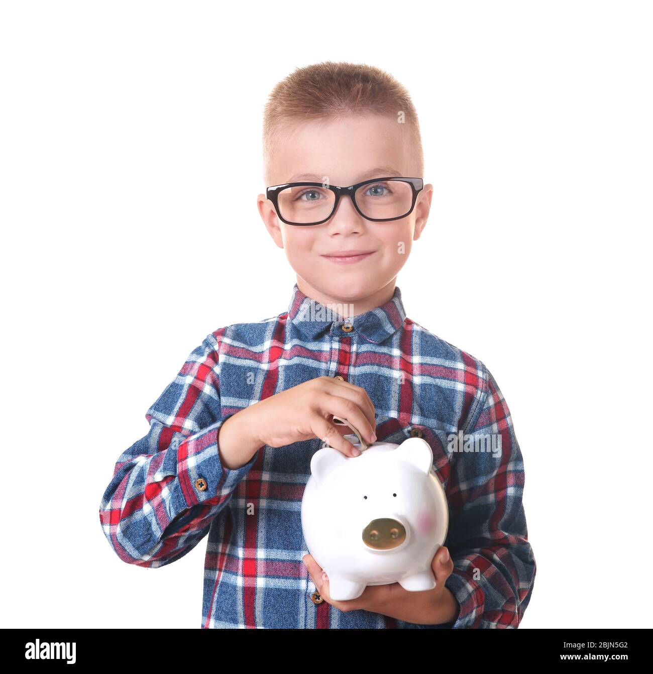 Cute little boy putting money into piggy bank on white background Stock ...