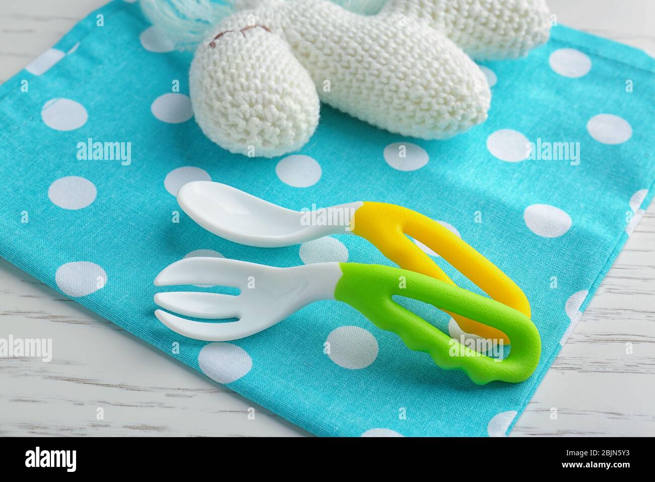 Colorful plastic eating utensils for baby on table Stock Photo Alamy