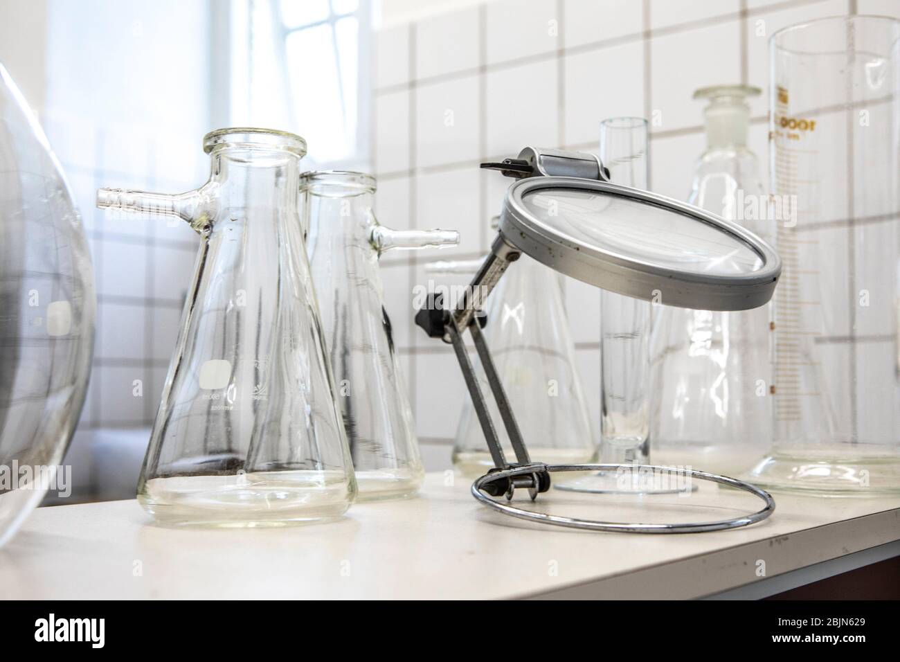 Old magnifying glass and conical flasks in a laboratory Stock Photo Alamy